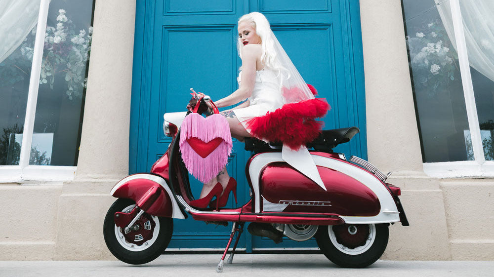 Bride with long blonde hair on a moped