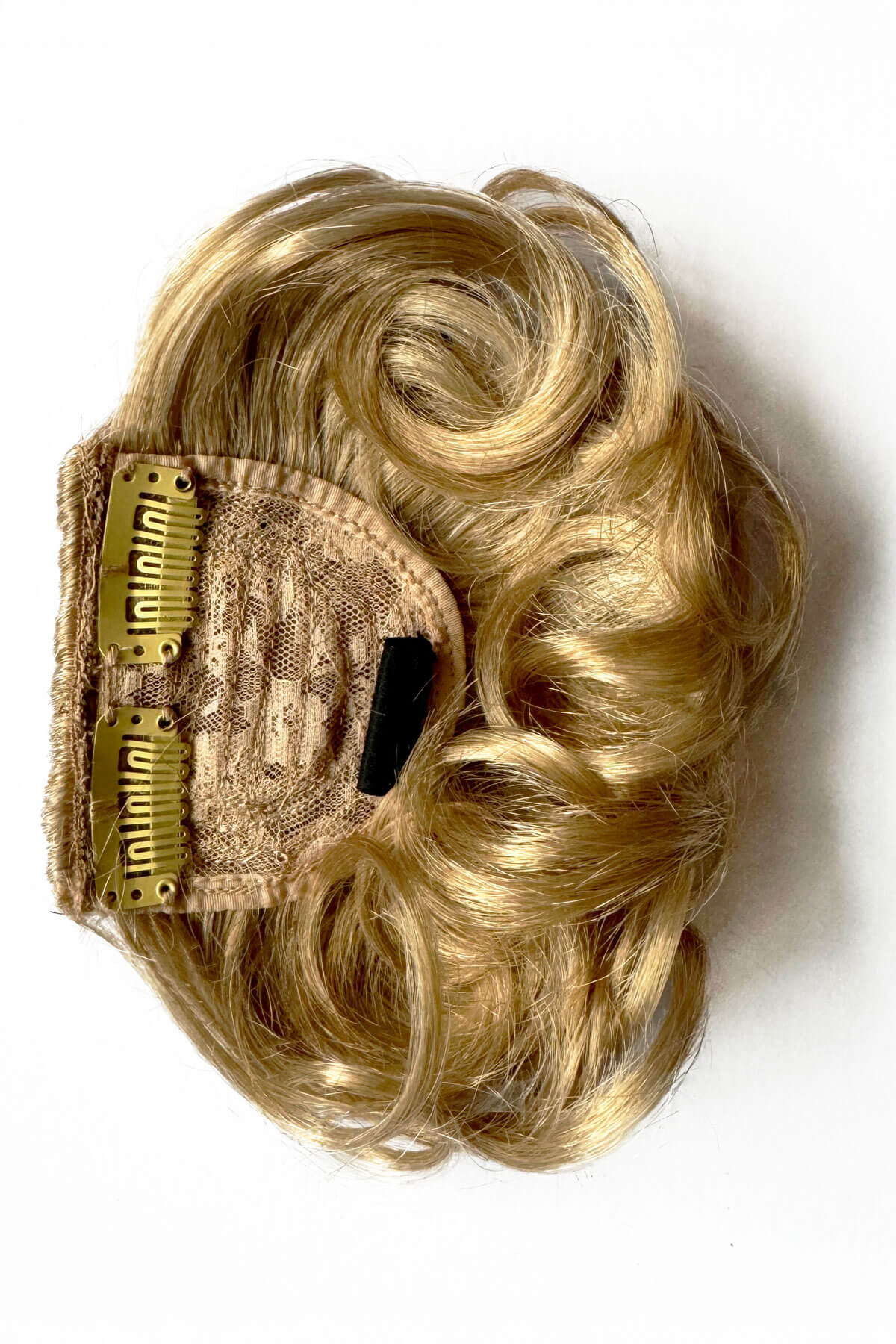 Blonde hair extension with a comb on a white background. Curly 1940s style clip-in fringe hairpiece/clip-in bangs: Bunny blonde 613T24