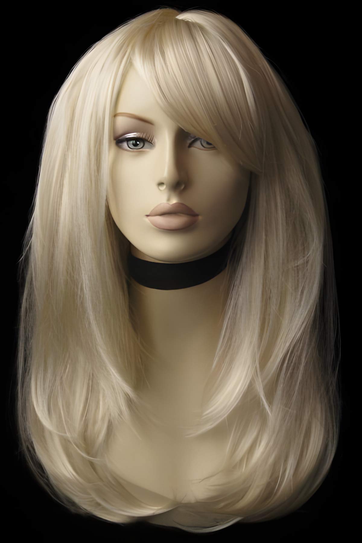 Blonde wig on a mannequin head against a black background. Long blonde wig, face framing with long, side-sweeping fringe: Ashley blonde 613