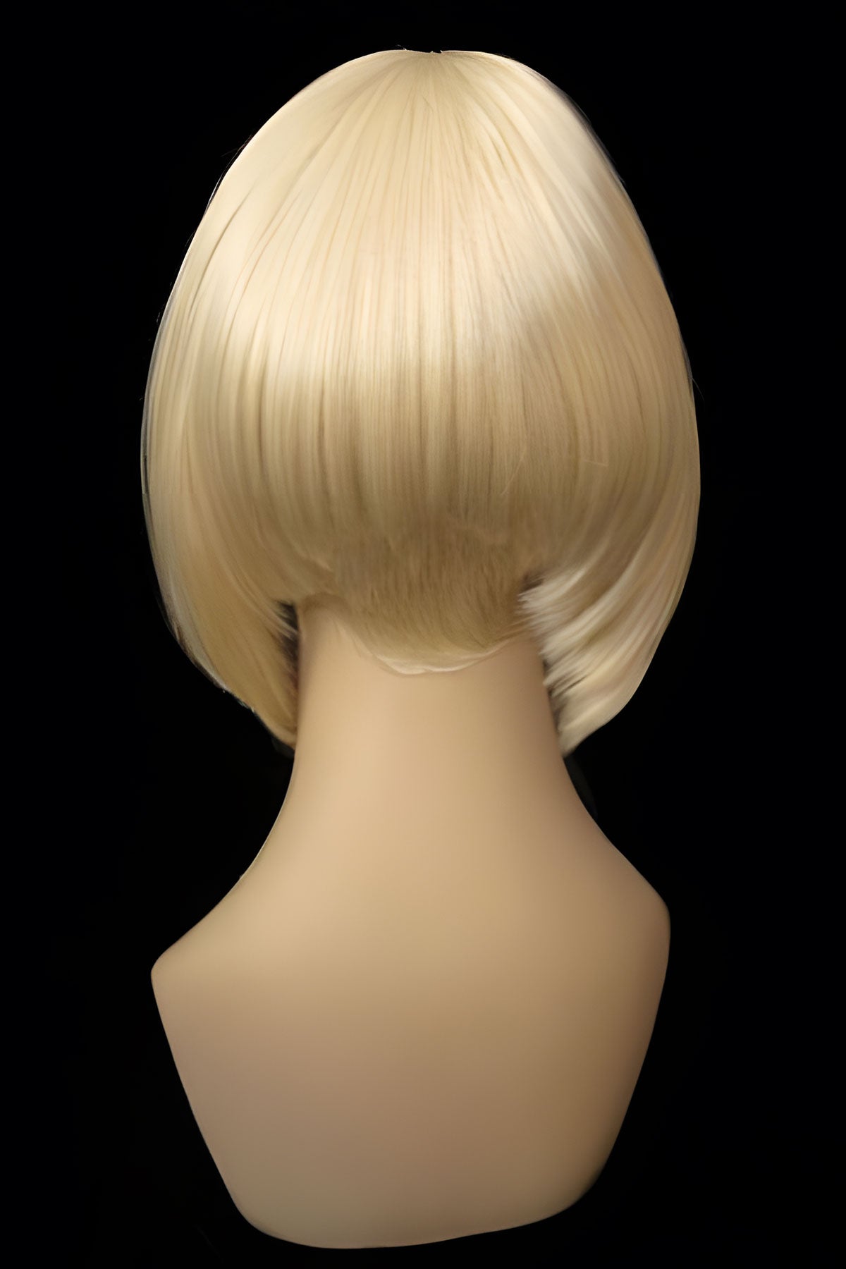 Blonde wig on a mannequin head against a black background.Blonde inverted bob wig: Rhiannon champagne blonde 613
