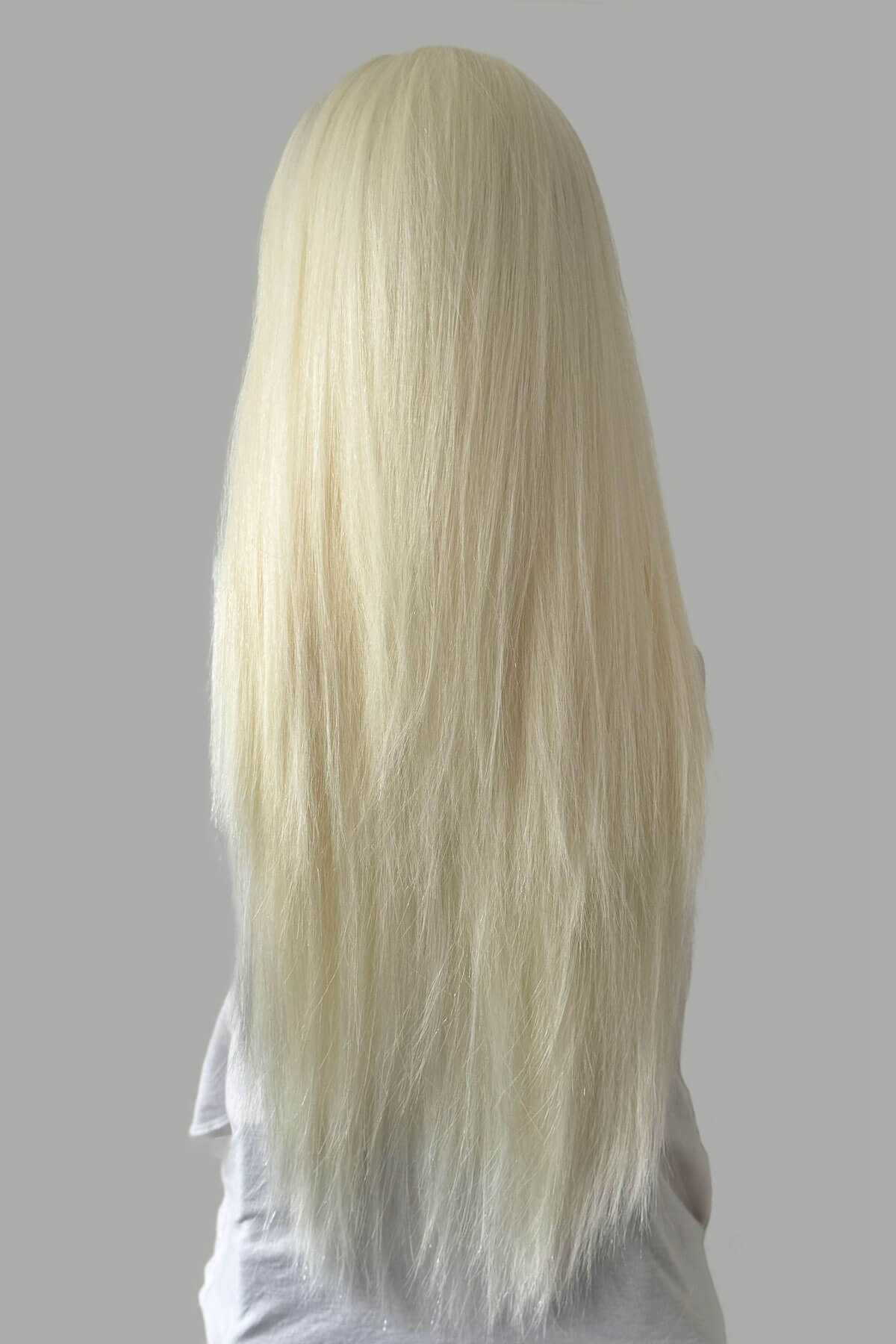 Long blonde wig on a gray background. Straight platinum blonde half wig hairpiece (3/4 wig): Shannon platinum 1001