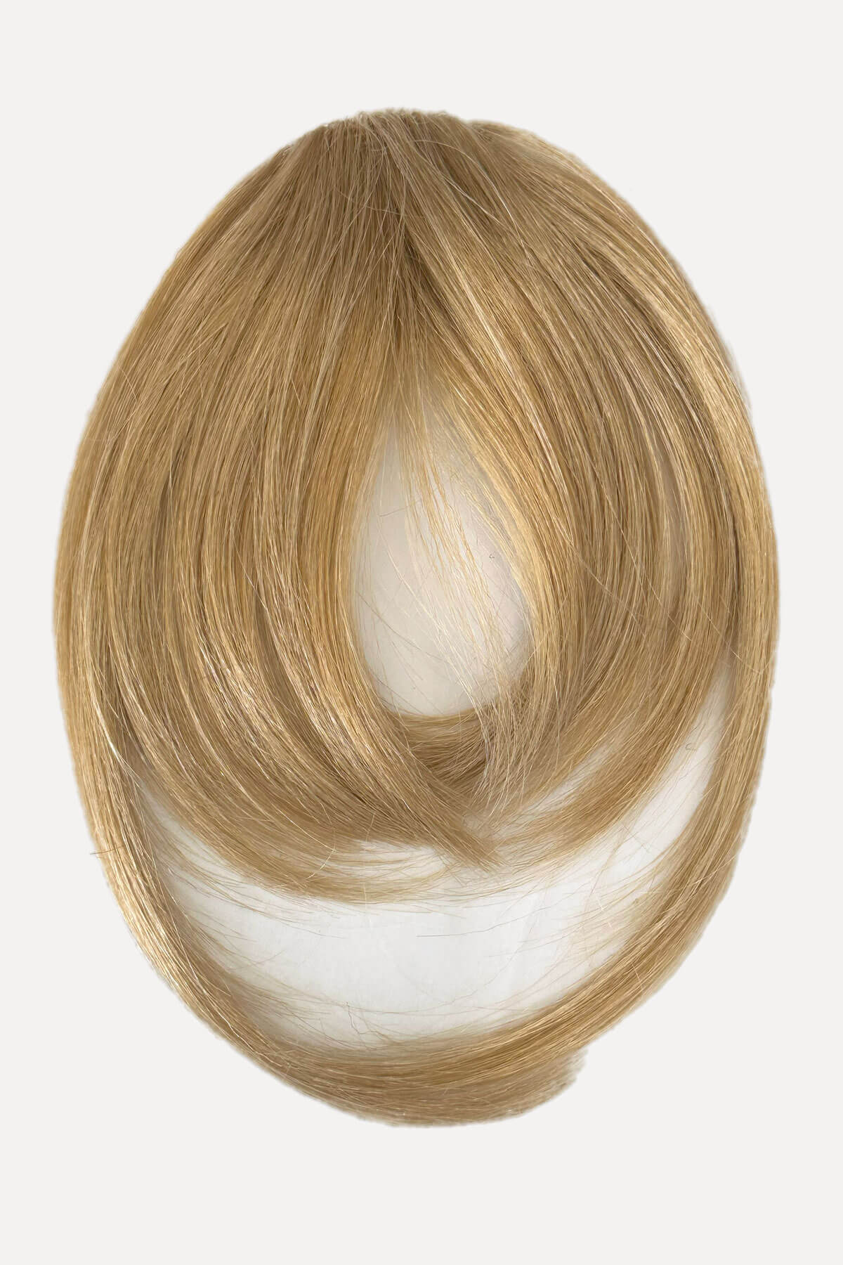 Blonde hair extension on a white background. Clip in fringe hairpiece/clip-in bangs, gently feathered with face framing whisps: Delia blonde 24H613