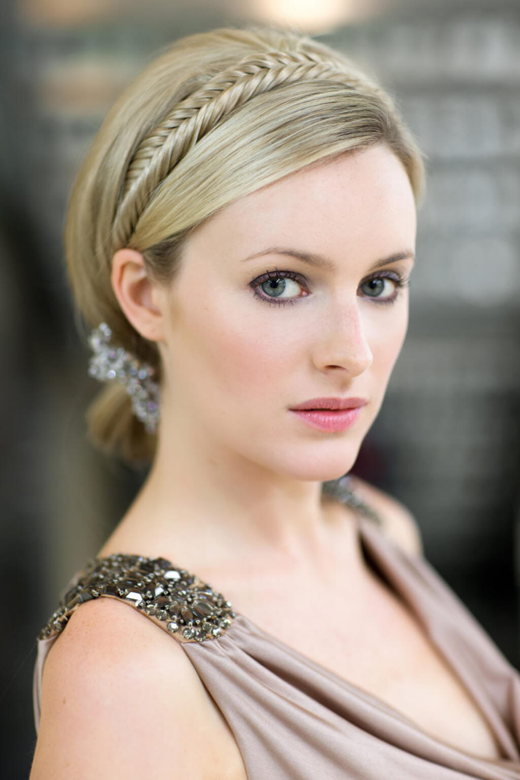 Woman with braided hair wearing a decorative headband and elegant dress. Fishtail plait hairband (braid) blonde 24H613