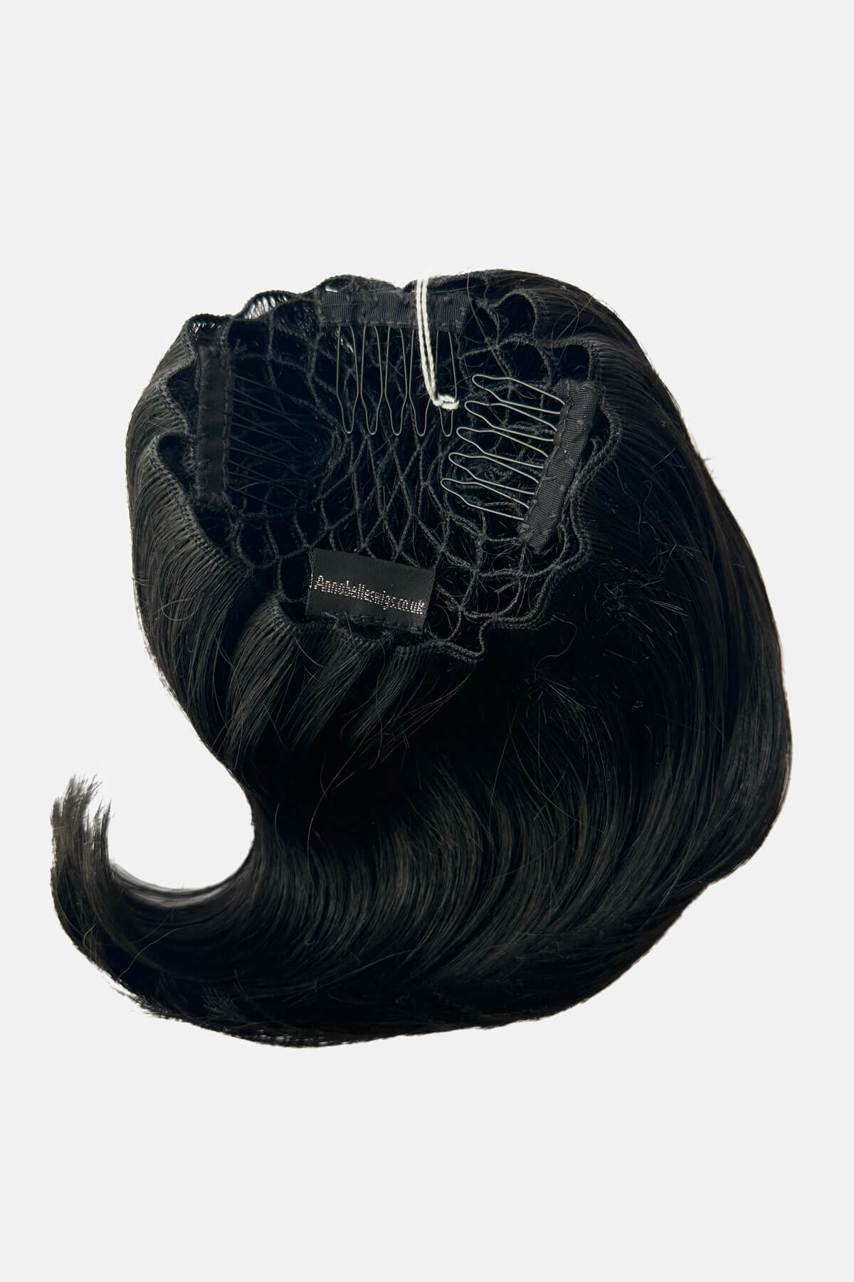 Black hair extension on a white background. Beehive hairpiece hair height booster, Flexihair: Pixi black 1B