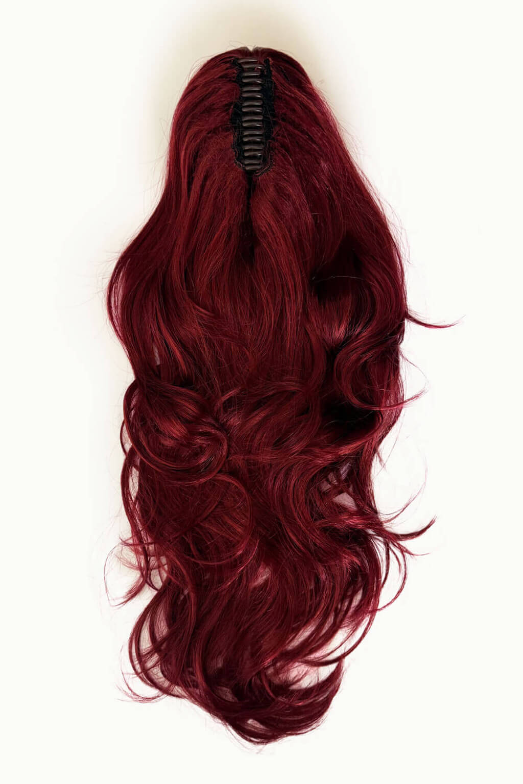 Red wig on a mannequin head against a white background. Clip-in ponytail hairpiece extension: Olivia Red 350-39