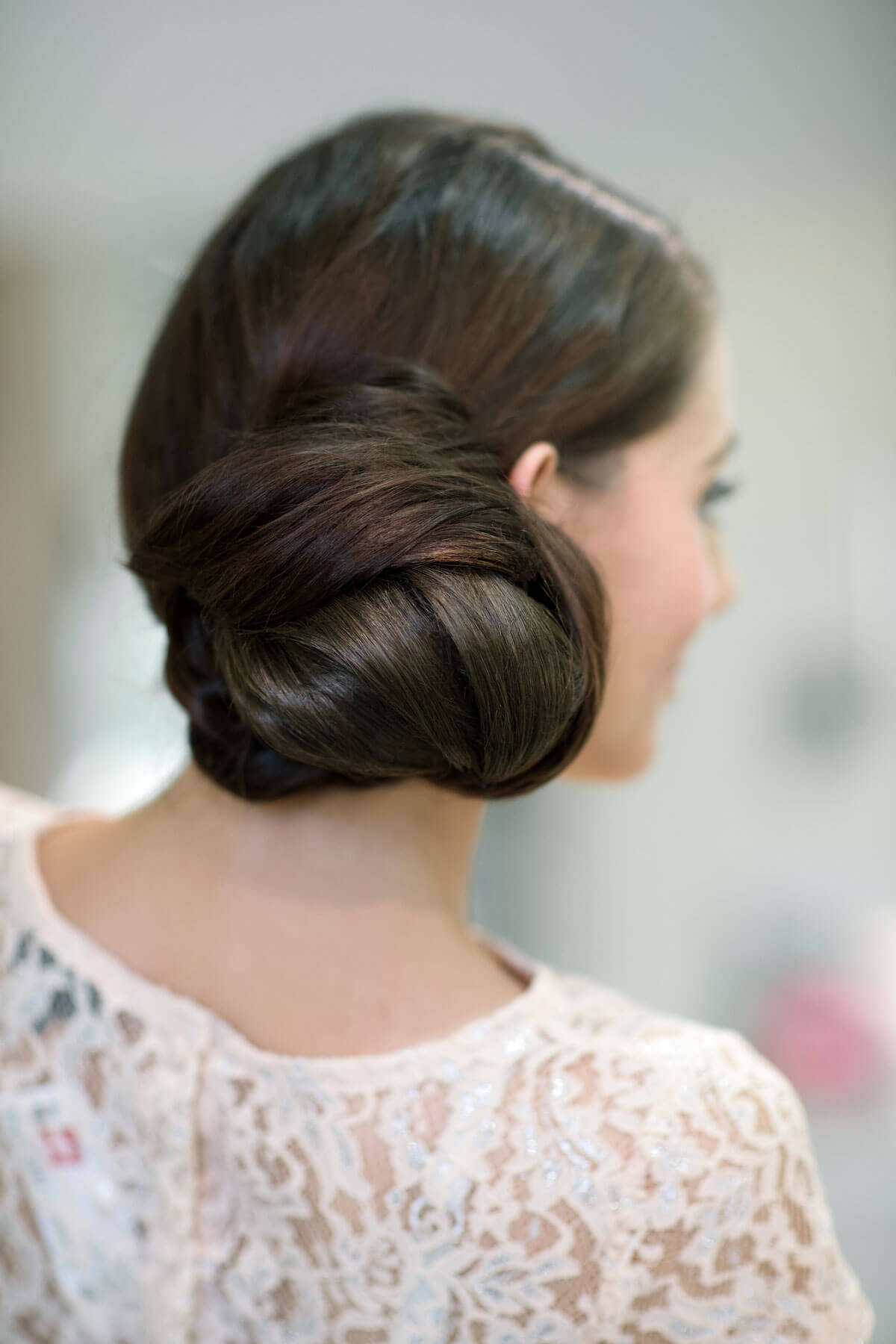 Woman with styled hair in an updo against a blurred background. Extension hairpiece, long, versatile, Flexihair: Cristina chestnut brown 8