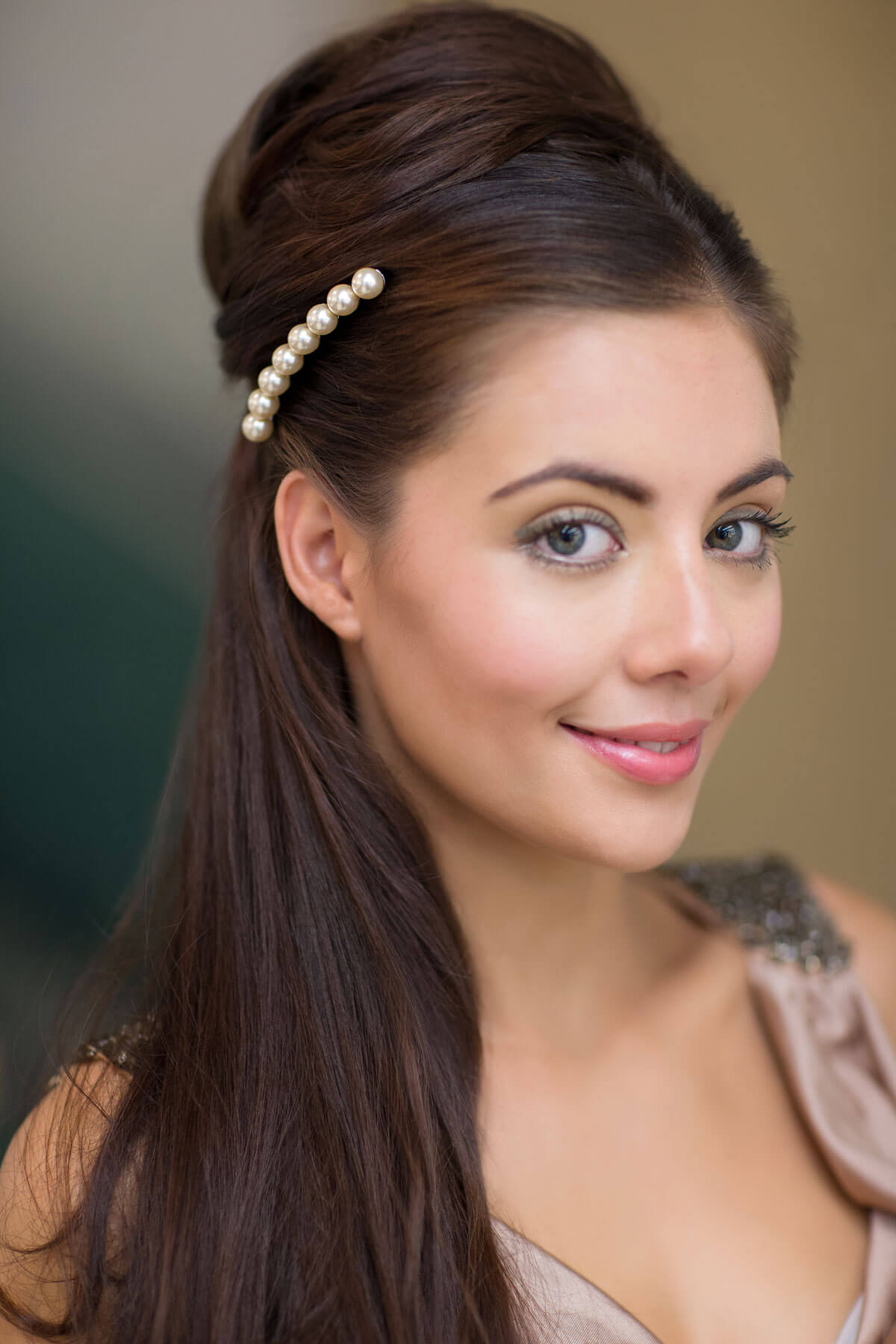 Woman with long brown hair wearing a pearl hair accessory against a neutral background. Extension hairpiece, long, versatile, Flexihair: Cristina chestnut brown 8