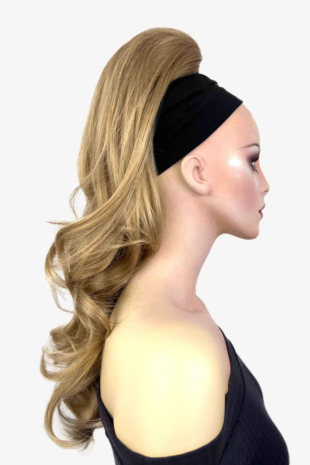 Woman wearing a black headband with styled blonde hair on a white background. Wavy, long ponytail hairpiece extension: Casey ash blonde 24