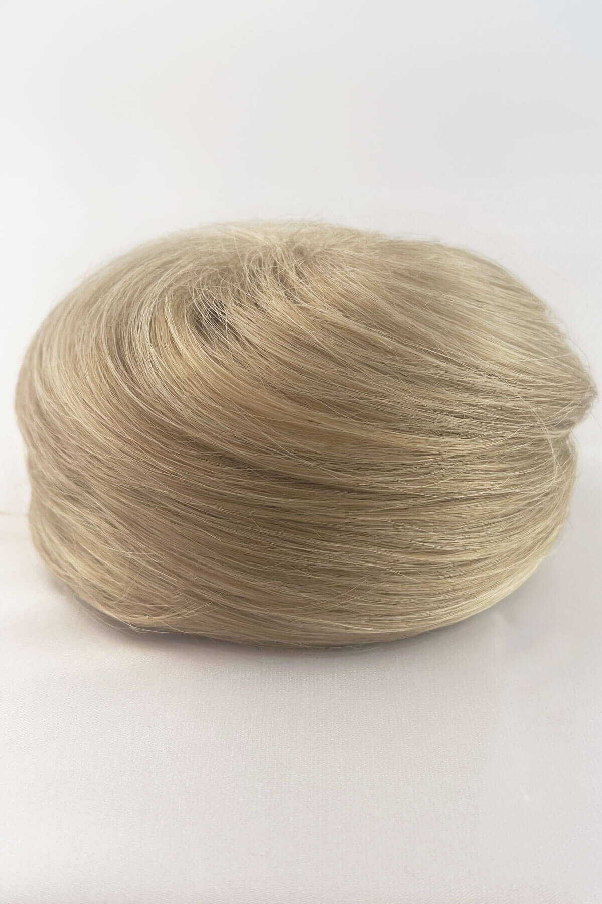 Light blonde hair bun on a white background. Hairpiece bun; instant perfect bun hairpiece: Hepburn blonde 613T24