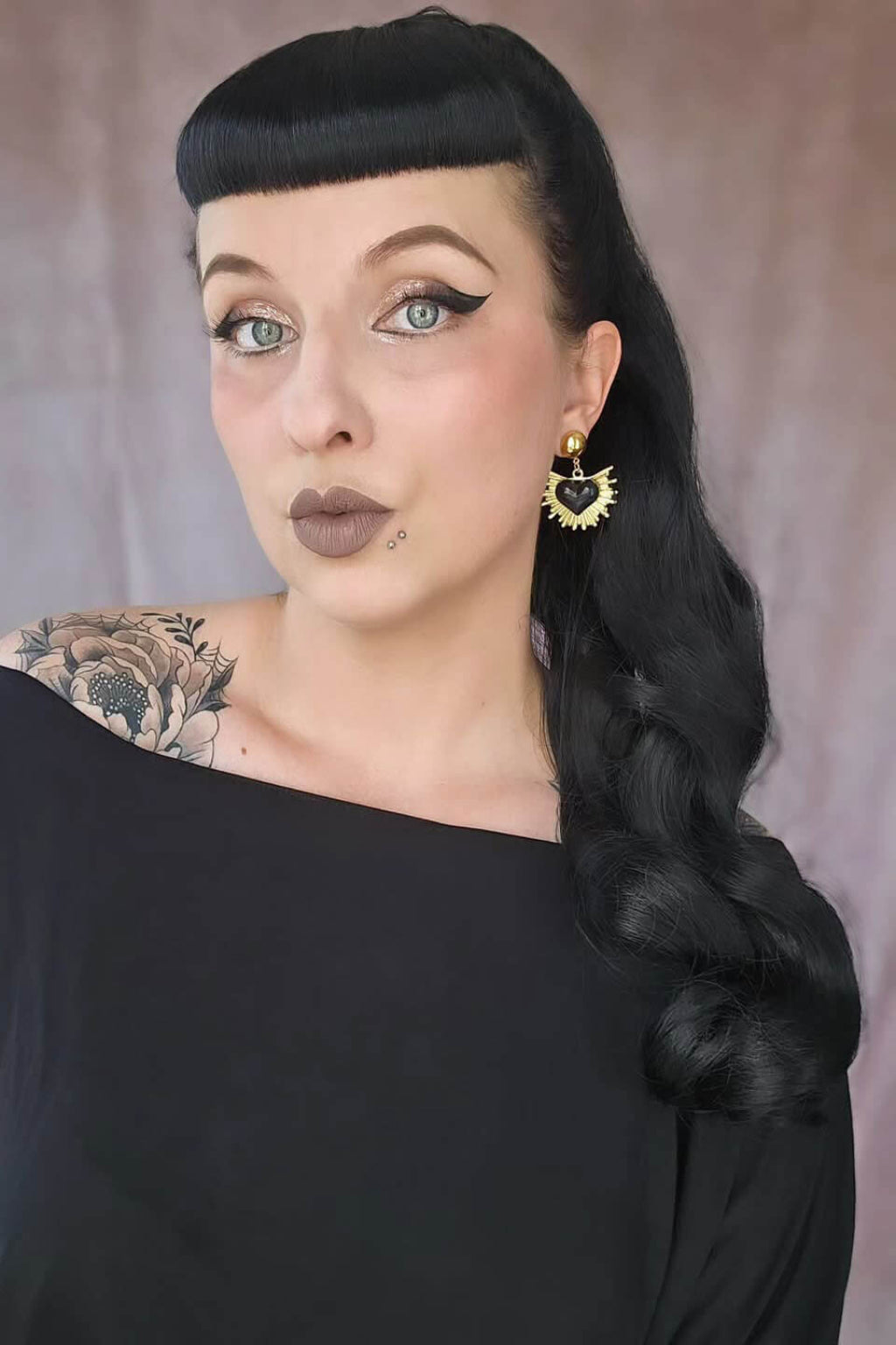 Woman with black hair styled in a braid, wearing a black top against a neutral background. Long ponytail with vintage waves: Kitrysha jet black 1