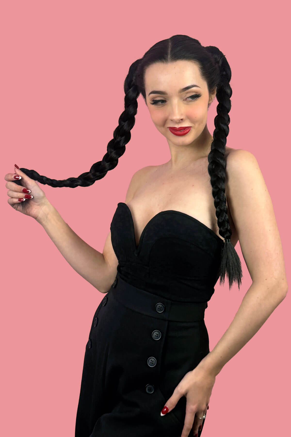 Woman with long braided hair wearing a black dress. Long double plaited ponytail hairpiece: Martha Blonde 613T24