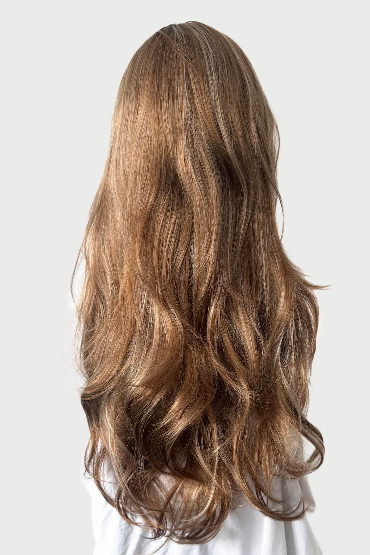 Mannequin with long brown and blonde wig. Light brown half wig with blonde highlights & loose waves: May