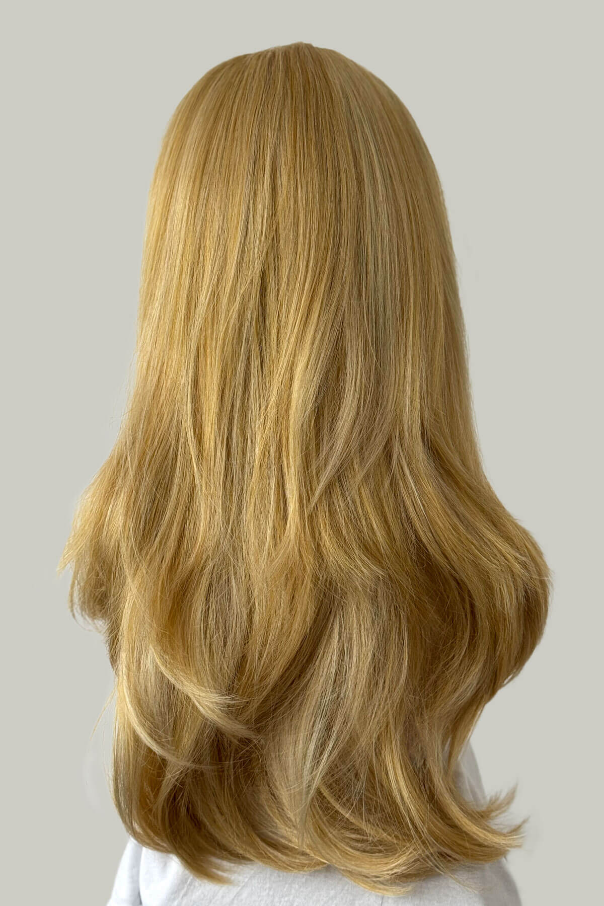 Blonde wig on a neutral background. Straight blonde half wig hairpiece (3/4 wig), layered: Autumn blonde 24BH613