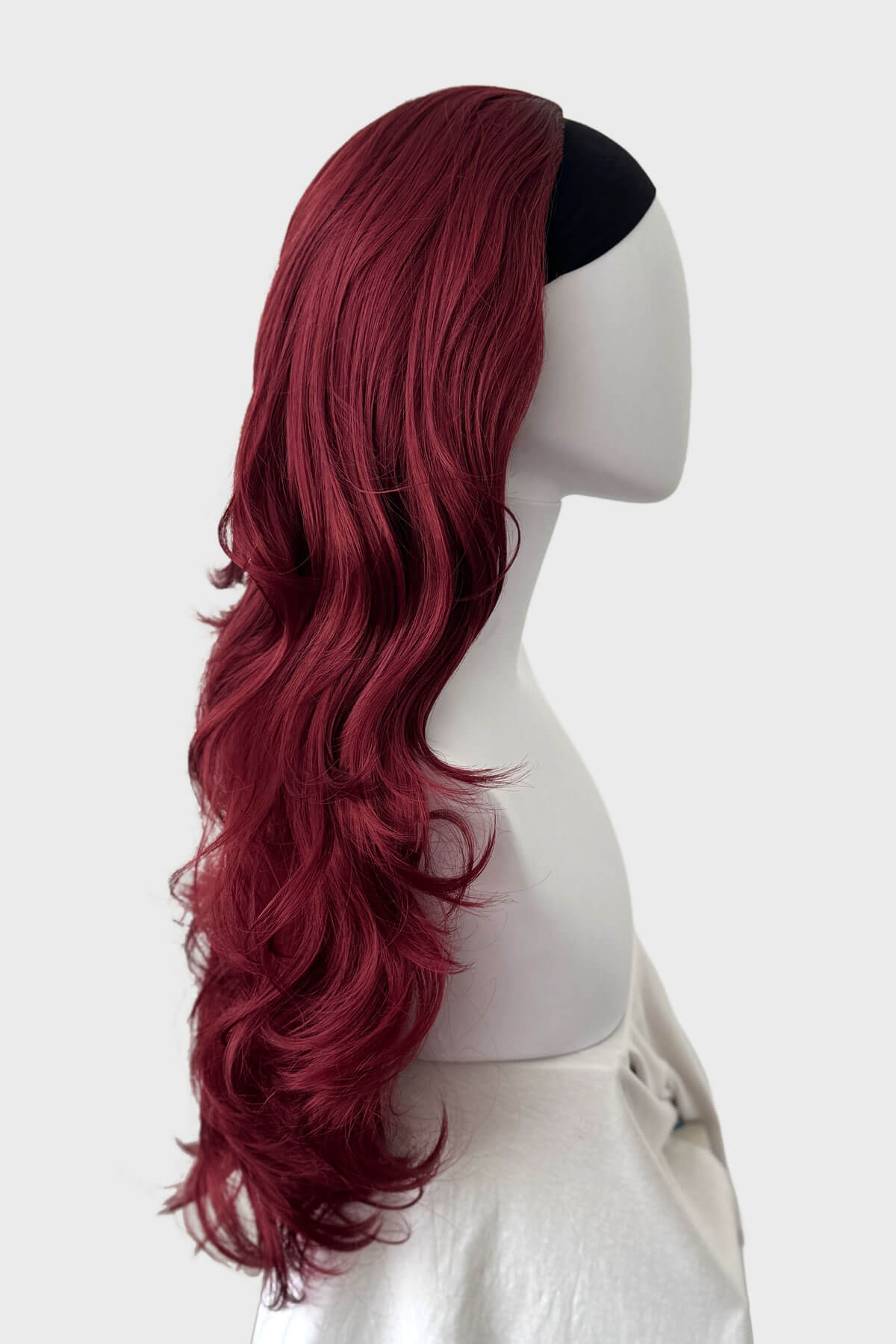 Mannequin head with long red wig and black headband on a white background. Red 3/4 wig hairpiece (half wig), big loose curls: Marie