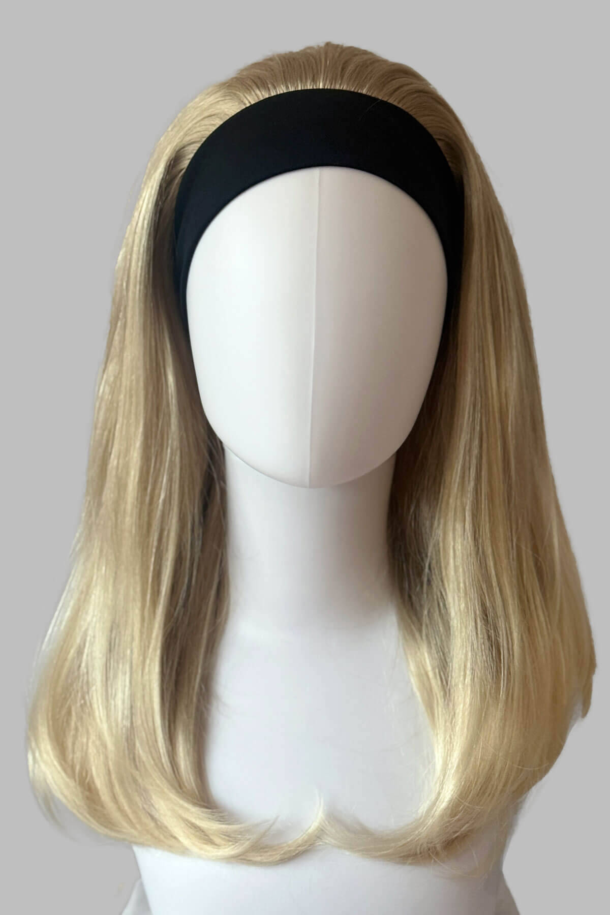 A close-up of a headband blonde half wig hairpiece showing the texture of the hair. Headband half wig hairpiece, long and straight: Isla Blonde 613T24