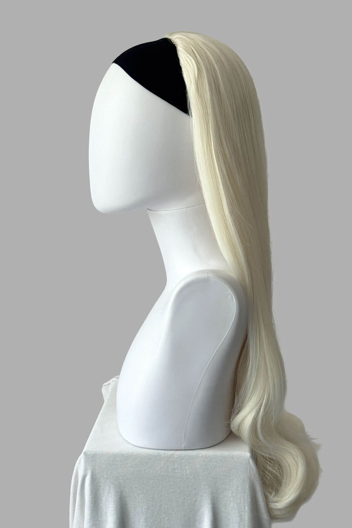 Long, platinum blonde half wig on a plain background. Kate - Heat Styleable Extra Long, Gentle Wave Half Wig dark platinum blonde 1001