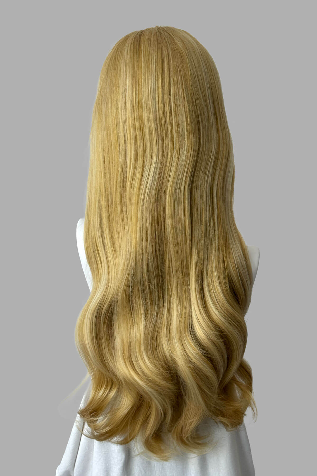 Mannequin head with warm blonde wig on a plain background. Kate - Heat Styleable Extra Long, Gentle Wave Half Wig blonde 24BH613
