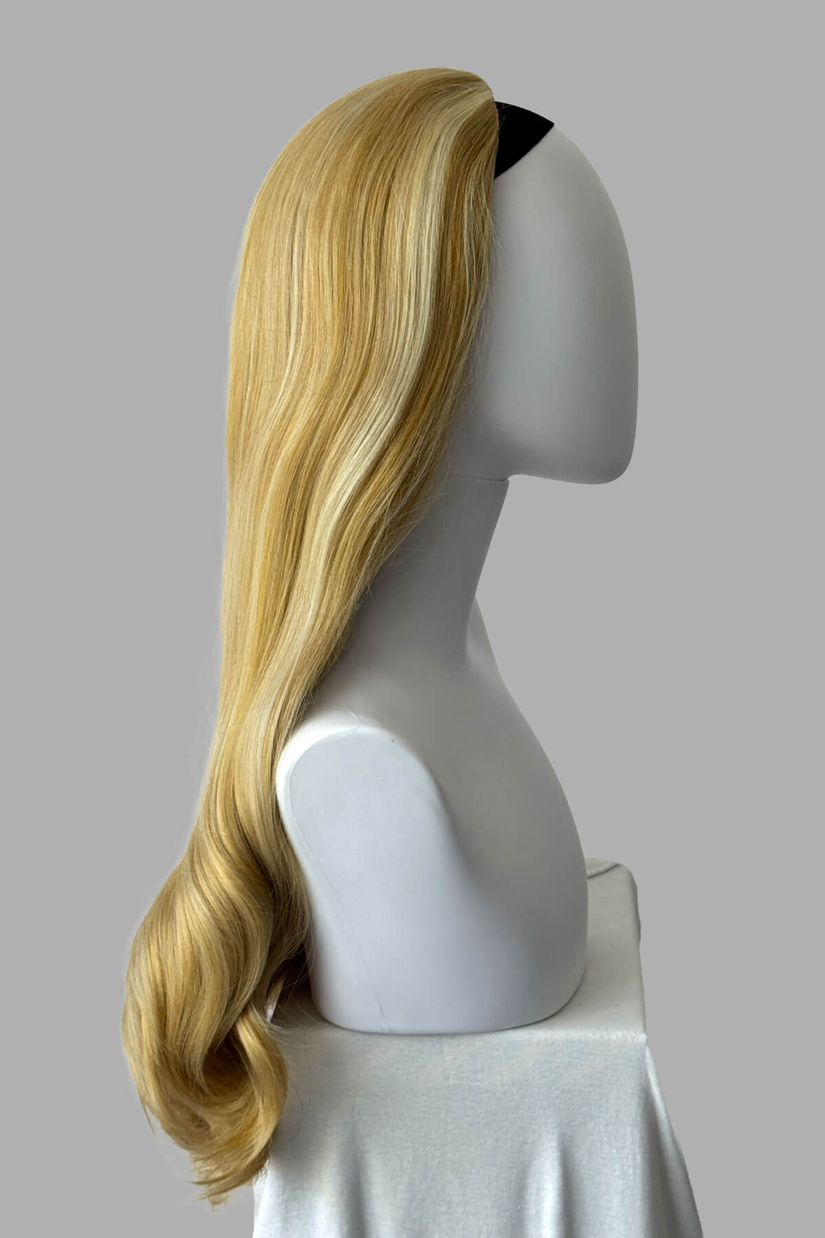 Mannequin head with warm blonde wig on a plain background. Kate - Heat Styleable Extra Long, Gentle Wave Half Wig blonde 24BH613