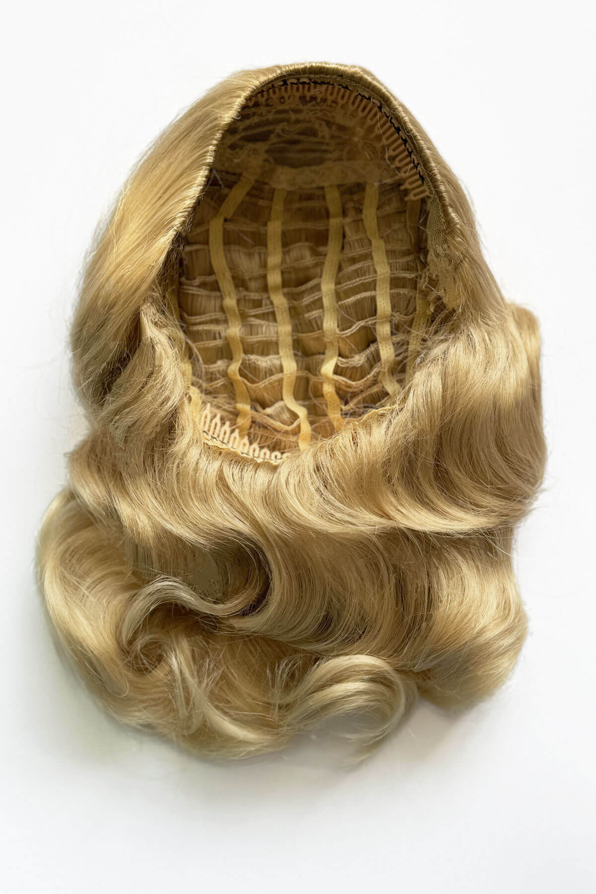 Blonde hairpiece with a white background. 1950s style shoulder length half wig hairpiece with beautiful vintage waves: Onyx blonde 613T24
