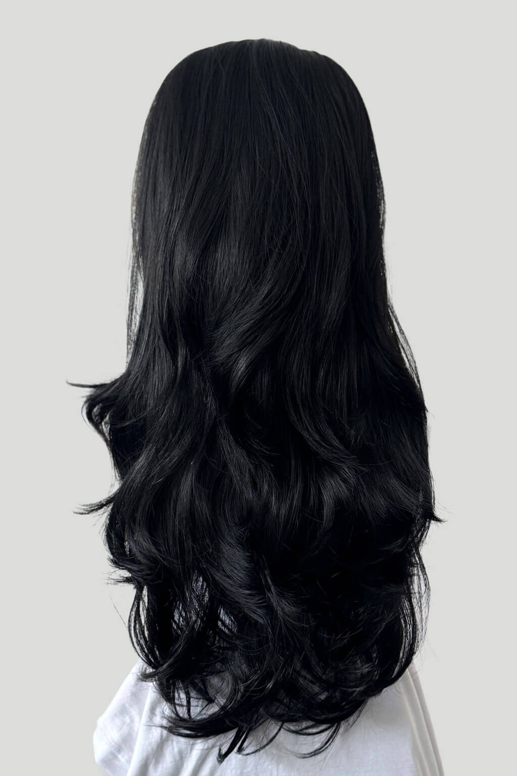 Long, black hair on a plain white background. High crown long, layered half wig and volume ring: Helena black 1b
