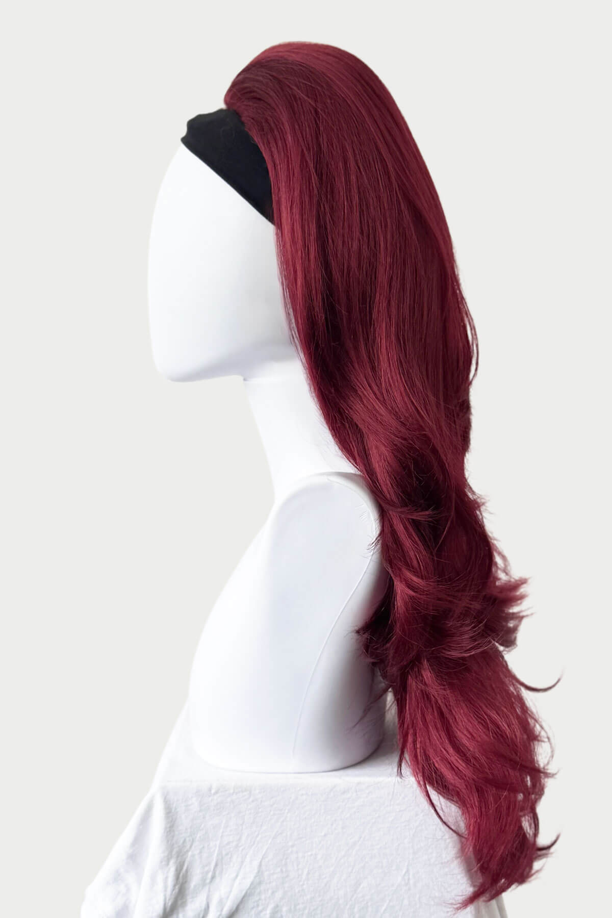 Red wig on a mannequin head against a white background. High crown long, layered half wig and volume ring: Helena cherry red 39