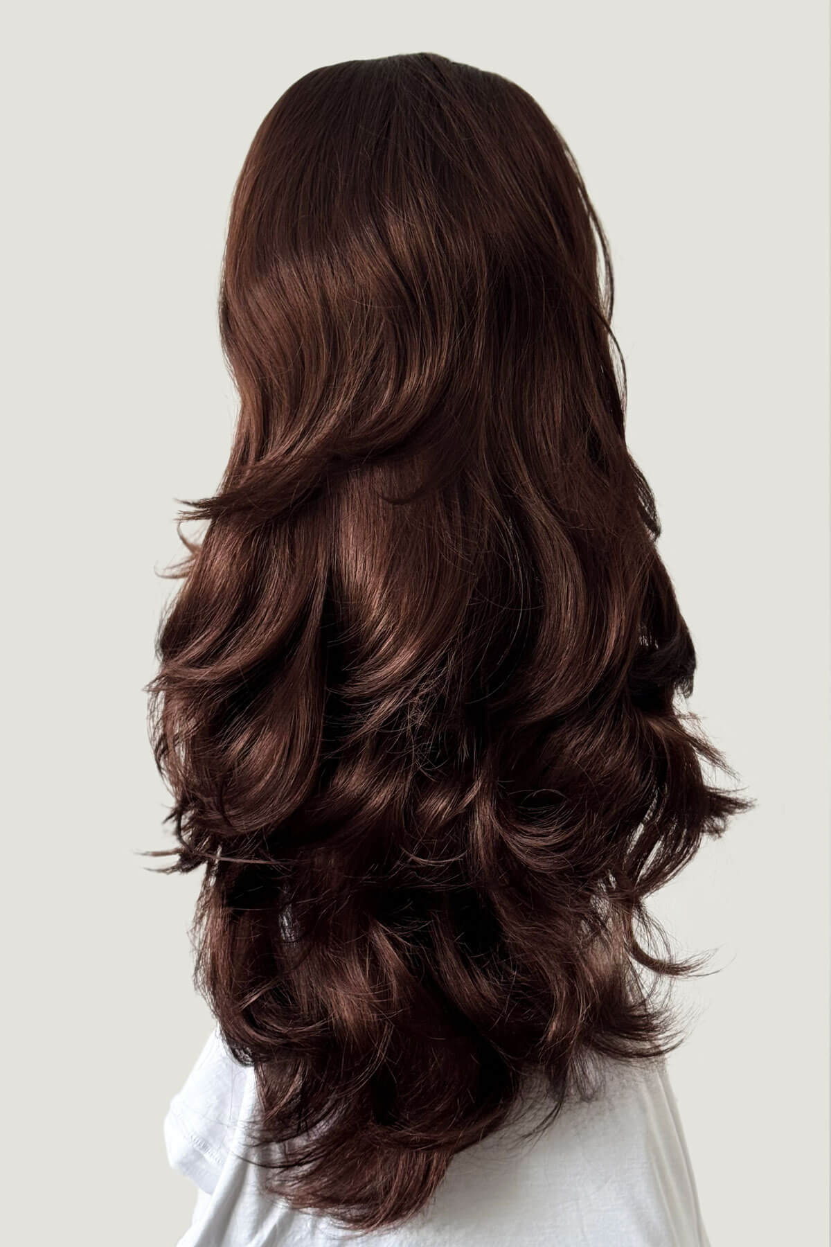 Long, wavy reddish brown hair on a white background. High crown long, layered half wig and volume ring: Helena reddish brown 33