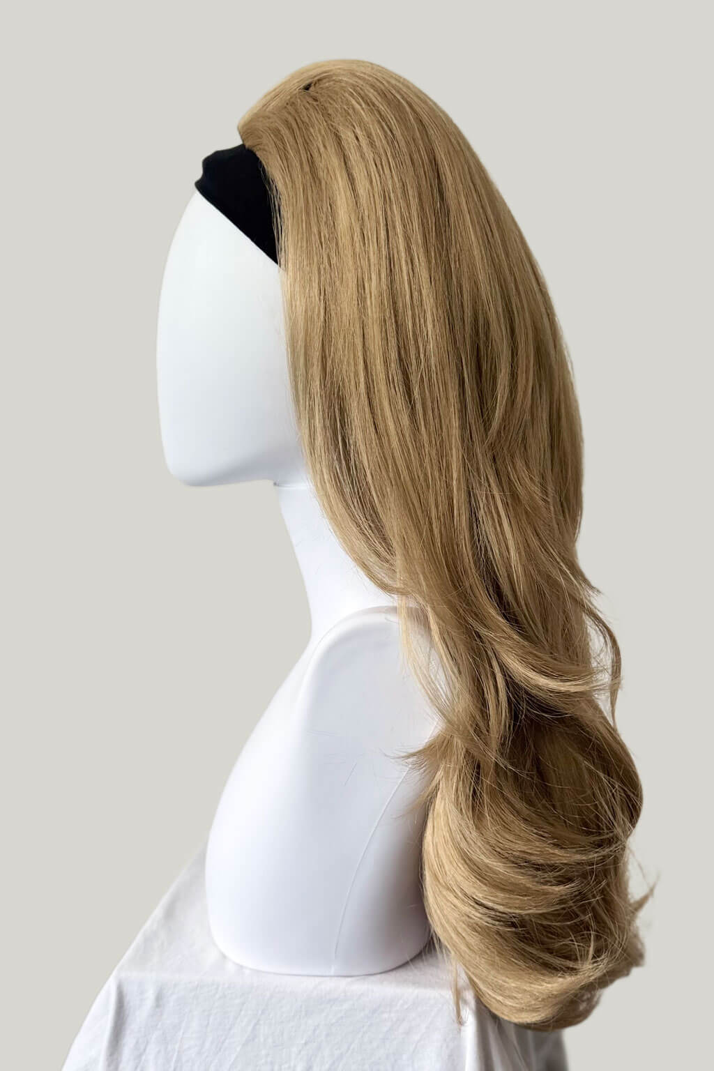 Blonde wig on a mannequin head against a plain background - High crown long, layered half wig and volume ring: Helena ash blonde 24