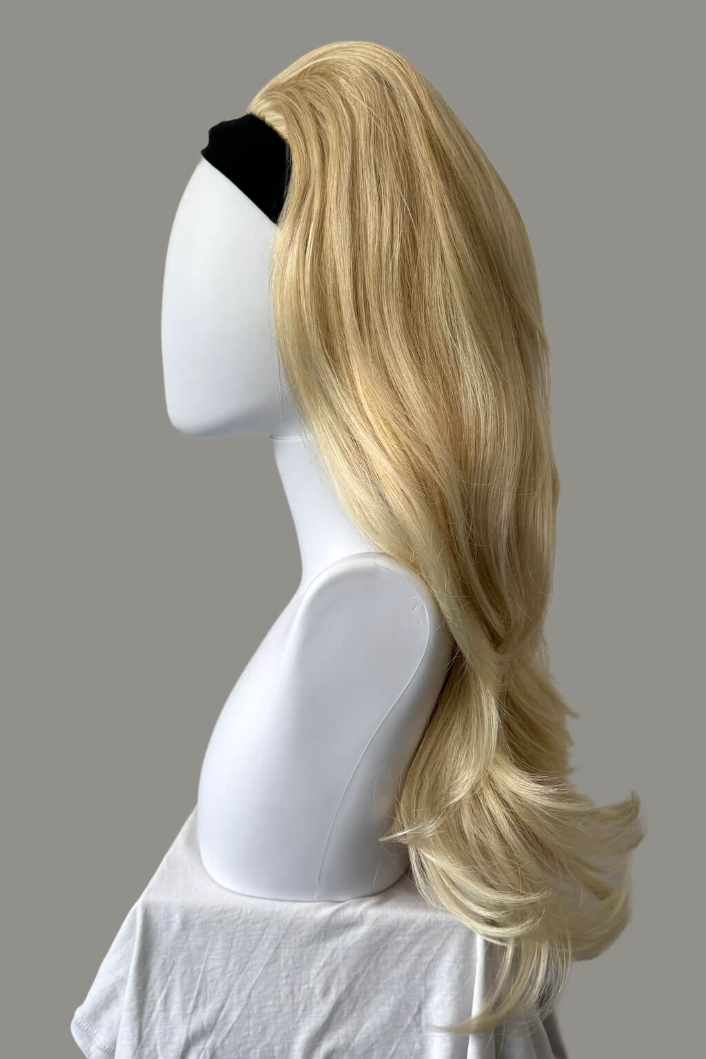 Blonde wig on a mannequin head against a gray background - High crown long, layered half wig and volume ring: Helena light ash blonde 24BT613