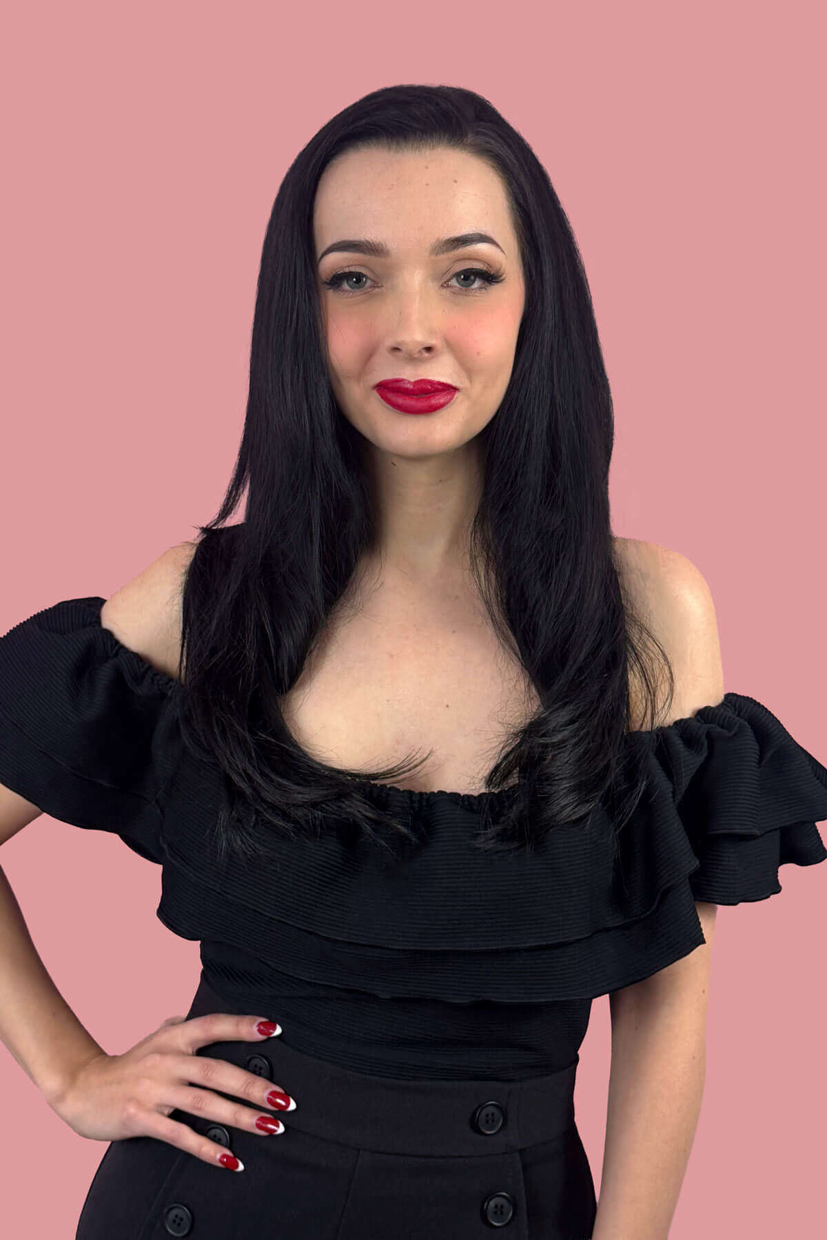Woman with long straight black hair wearing a black off-shoulder top against a pink background. Straight black half wig hairpiece, layered: Cerys
