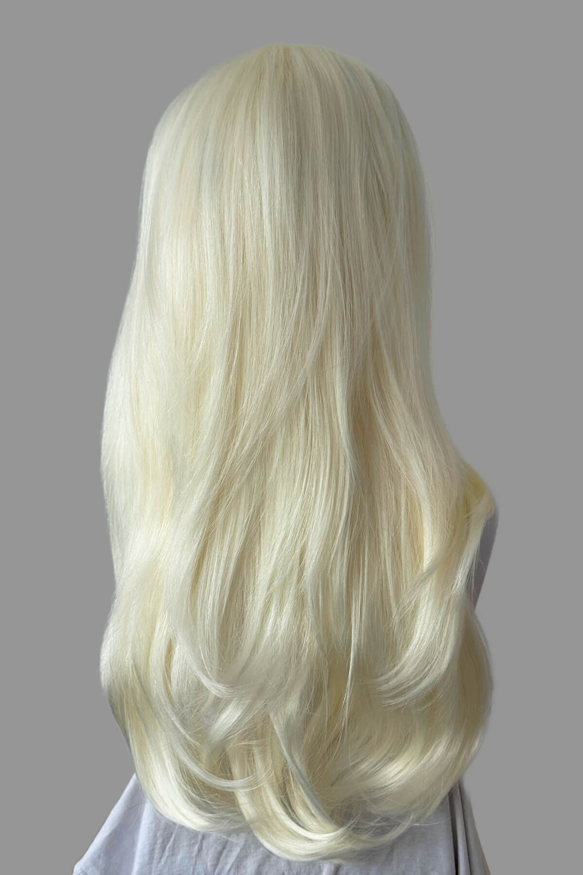 Blonde wig on a gray background. Platinum blonde half wig hairpiece (3/4 wig), straight: Gwen