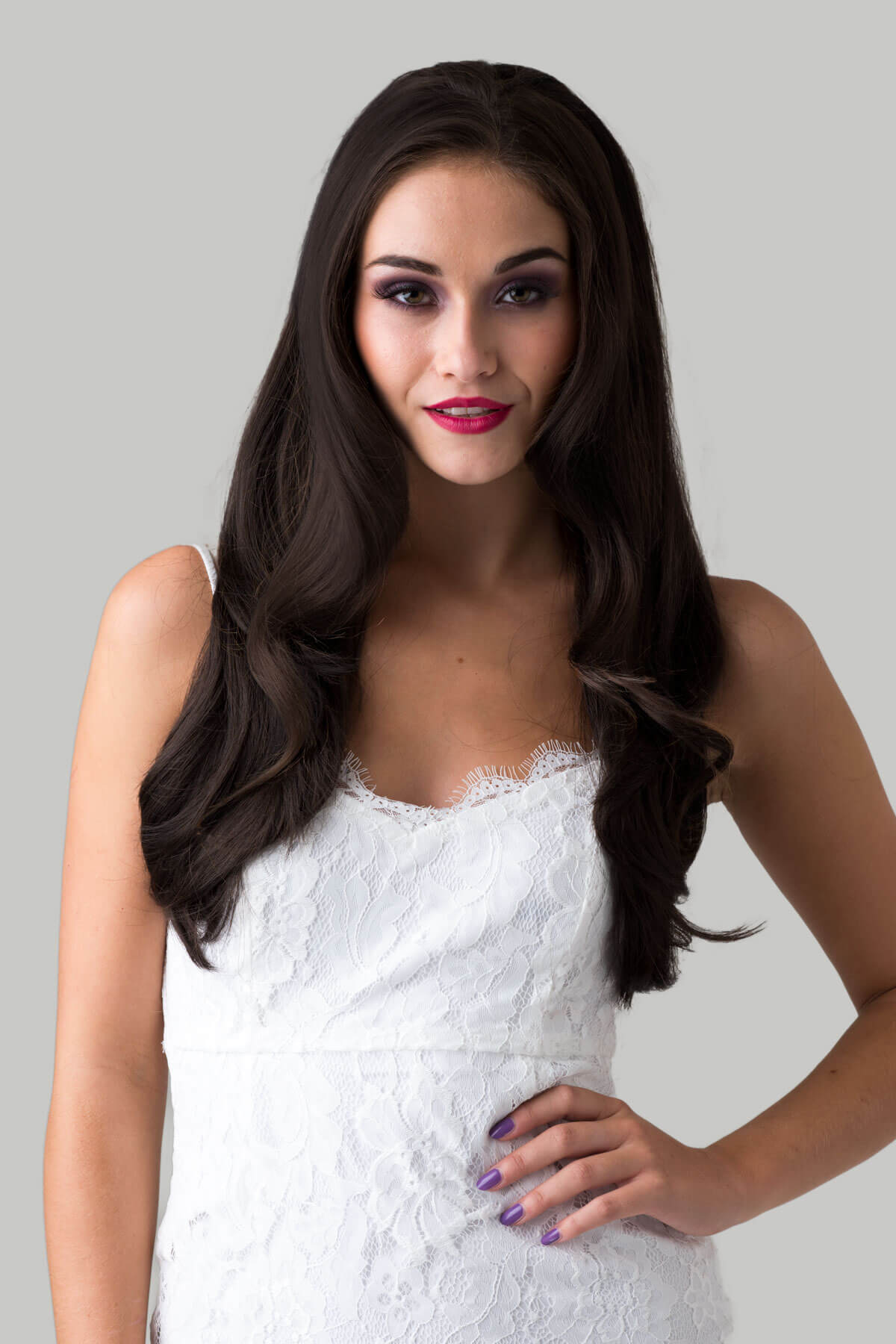 A woman wearing a brown half wig hairpiece with straight layers. She is smiling and wearing a white top. Brown half wig hairpiece, layered and straight: Summer dark chocolate brown 6