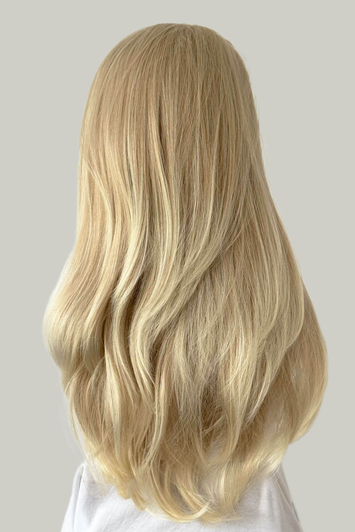 Blonde wig on a mannequin head against a plain background. Straight blonde half wig hairpiece (3/4 wig), layered: Autumn ash blonde to light blonde 613T24