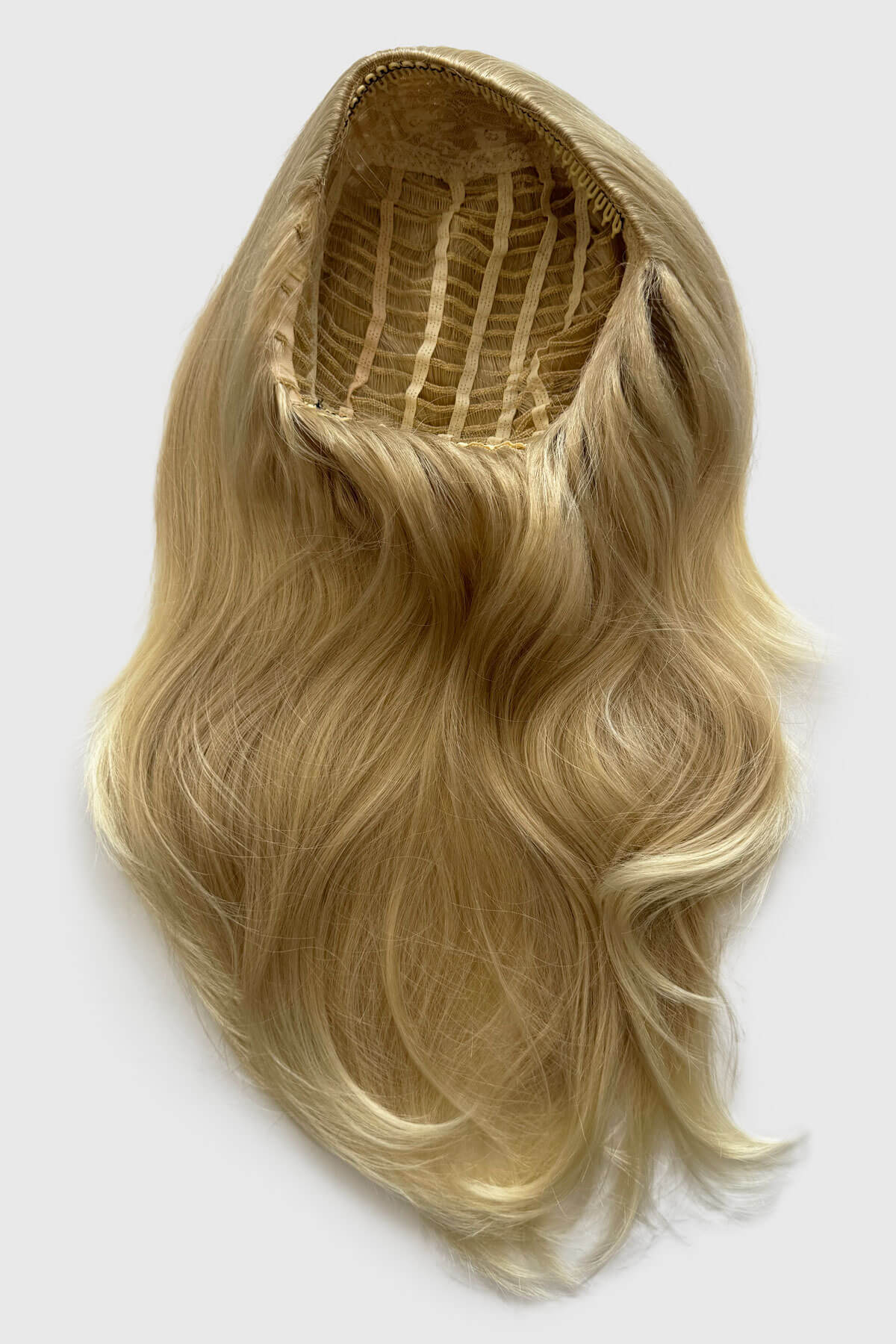 Blonde hair extension on a white background. Straight blonde half wig hairpiece (3/4 wig), layered: Autumn ash blonde to light blonde 613T24