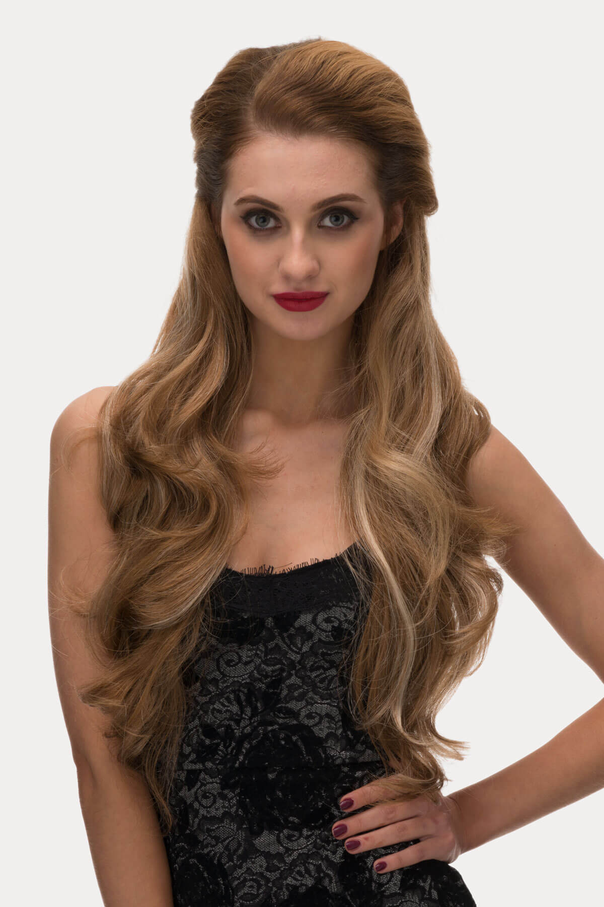 Woman with long, wavy hair wearing a black dress on a white background. Light brown half wig with blonde highlights & loose waves: May