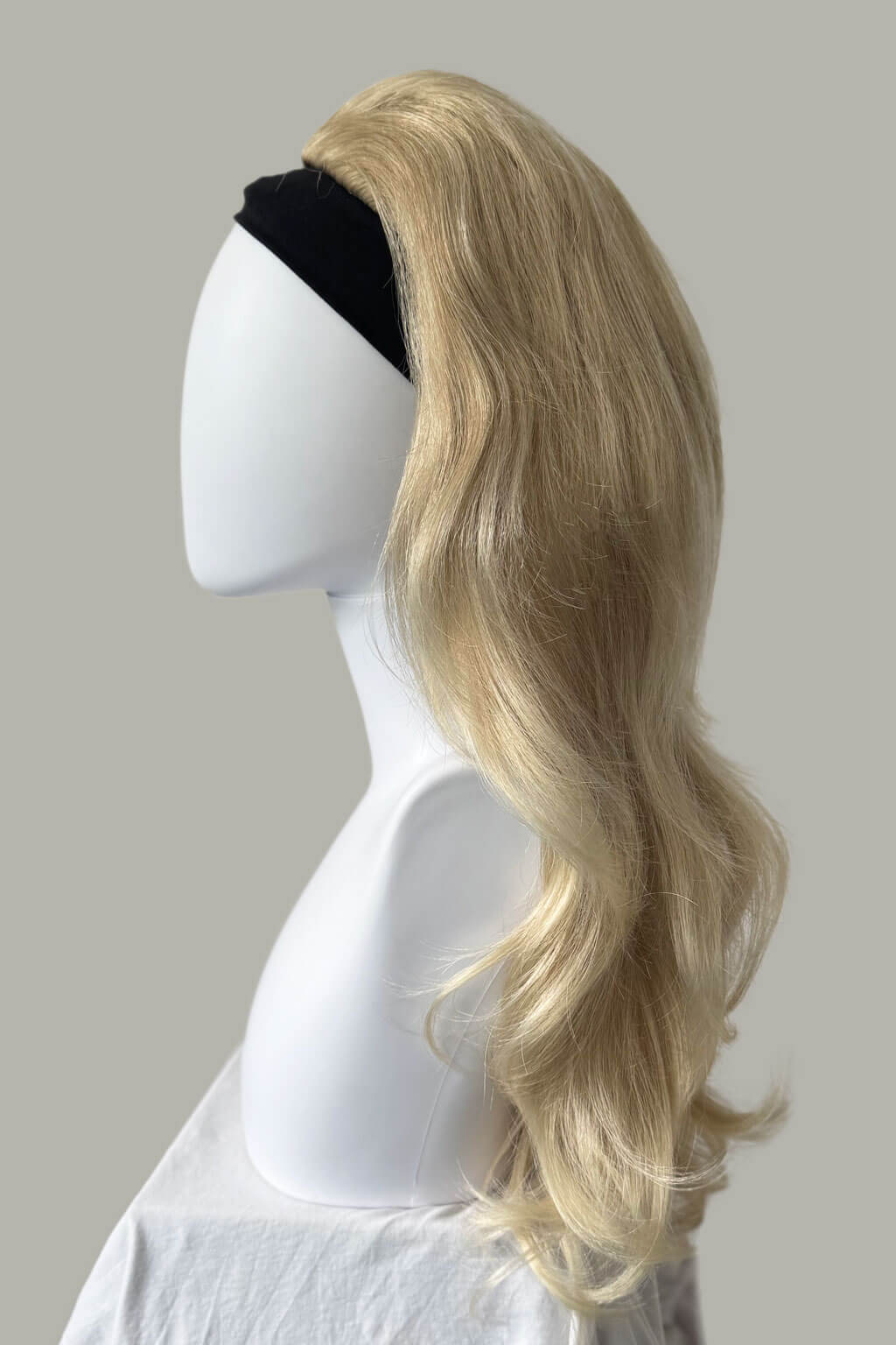 Blonde wig on a mannequin head against a plain background - High crown long, layered half wig and volume ring: Helena blonde 613T24