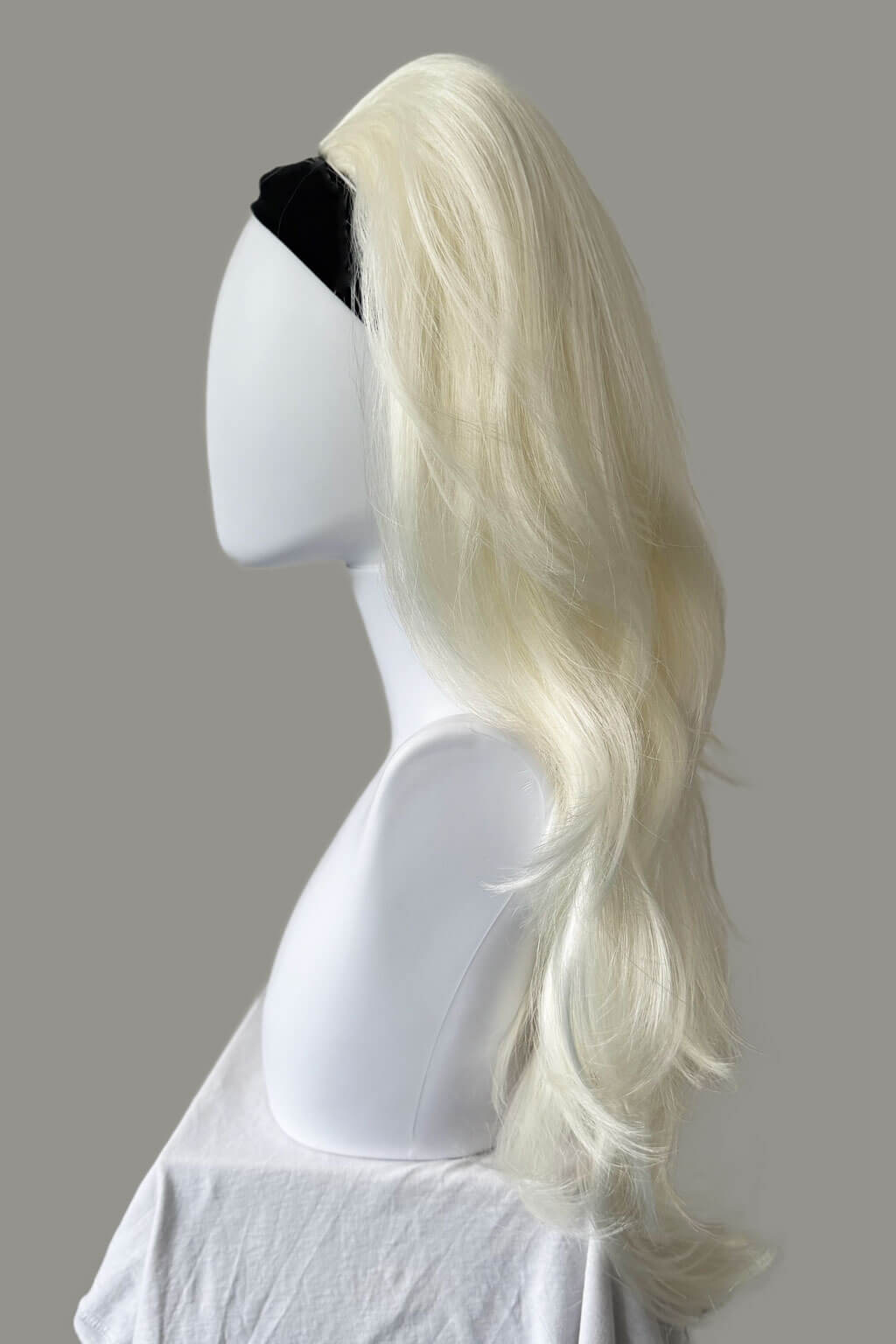 Blonde wig on a mannequin head against a gray background - High crown long, layered half wig and volume ring: Helena platinum 1001
