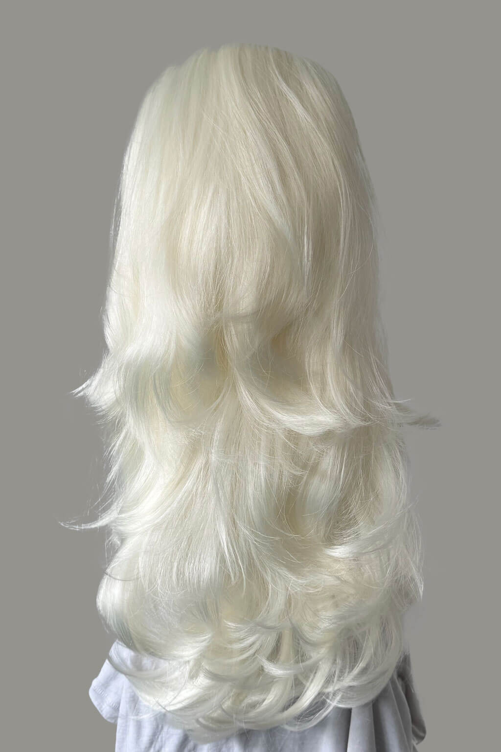 White wig on a gray background - High crown long, layered half wig and volume ring: Helena platinum 1001