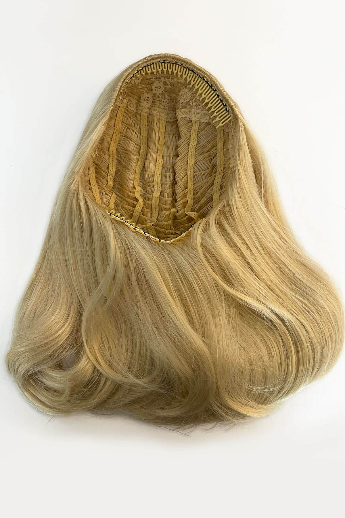 Blonde hair extension on a white background. 1960s half wig hairpiece, flicked, hair flip: Philippa blonde 613