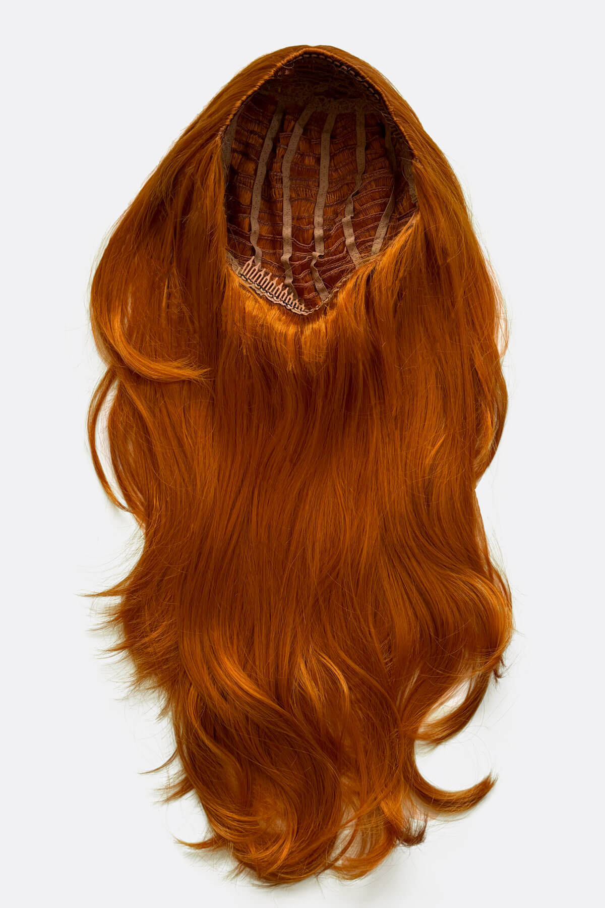 Orange hair extension on a white background. Wavy ginger half wig hairpiece extension (3/4 wig): Eris