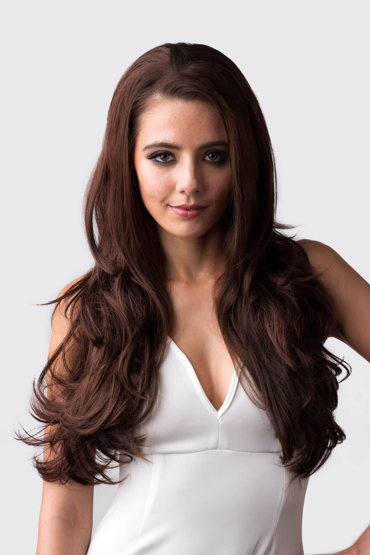 Woman with long brown hair wearing a white dress against a light gray background. Reddish brown half wig hairpiece with long, gentle waves: Heather reddish brown 33