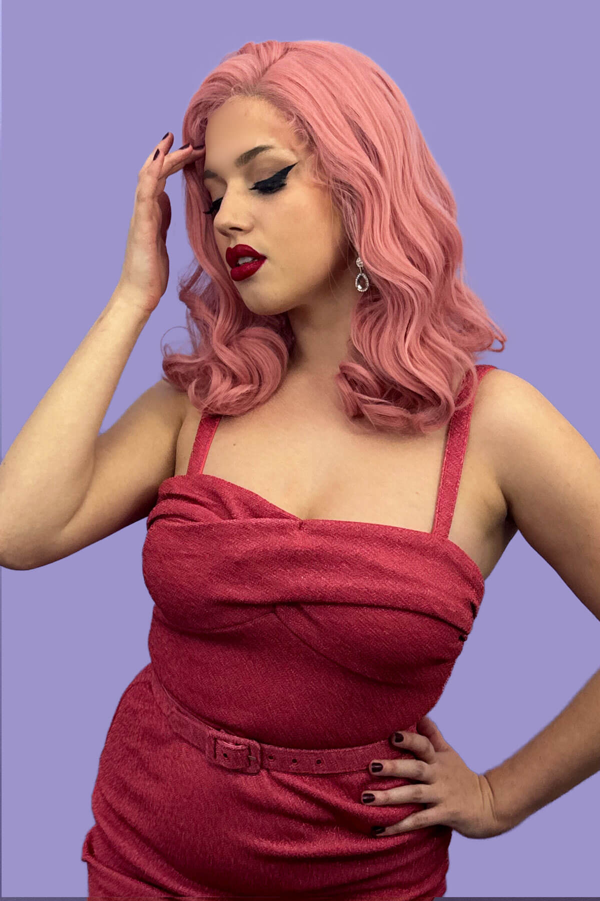 Woman with pink hair wearing a red dress against a purple background. Pink pinup wig, lace front, vintage style: Catalina