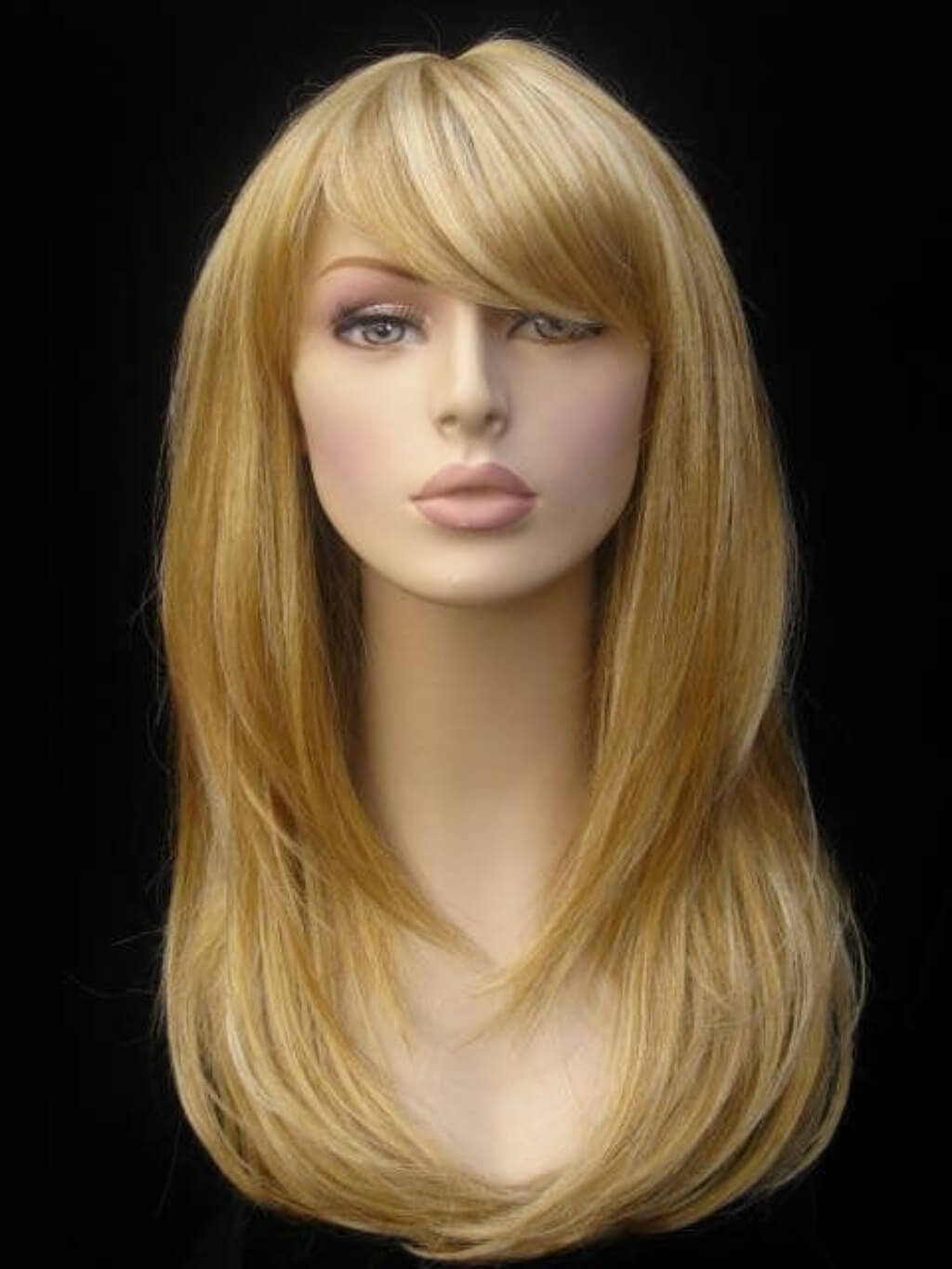 Blonde wig on a mannequin head against a black background. Long blonde wig, face framing with long, side-sweeping fringe: Ashley golden blonde 24BH613