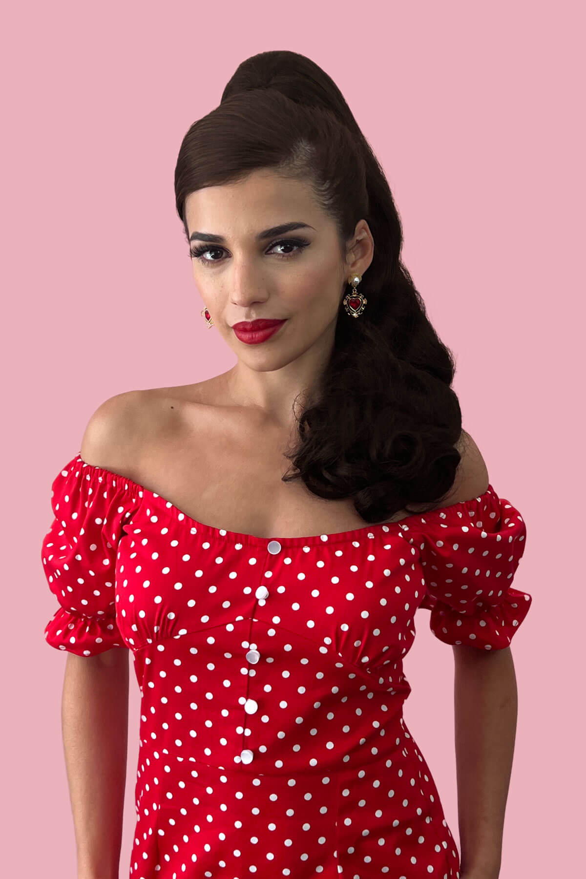 Woman wearing a red polka dot dress against a pink background. Retro style ponytail hairpiece, long with vintage waves: Arabella chestnut brown 8
