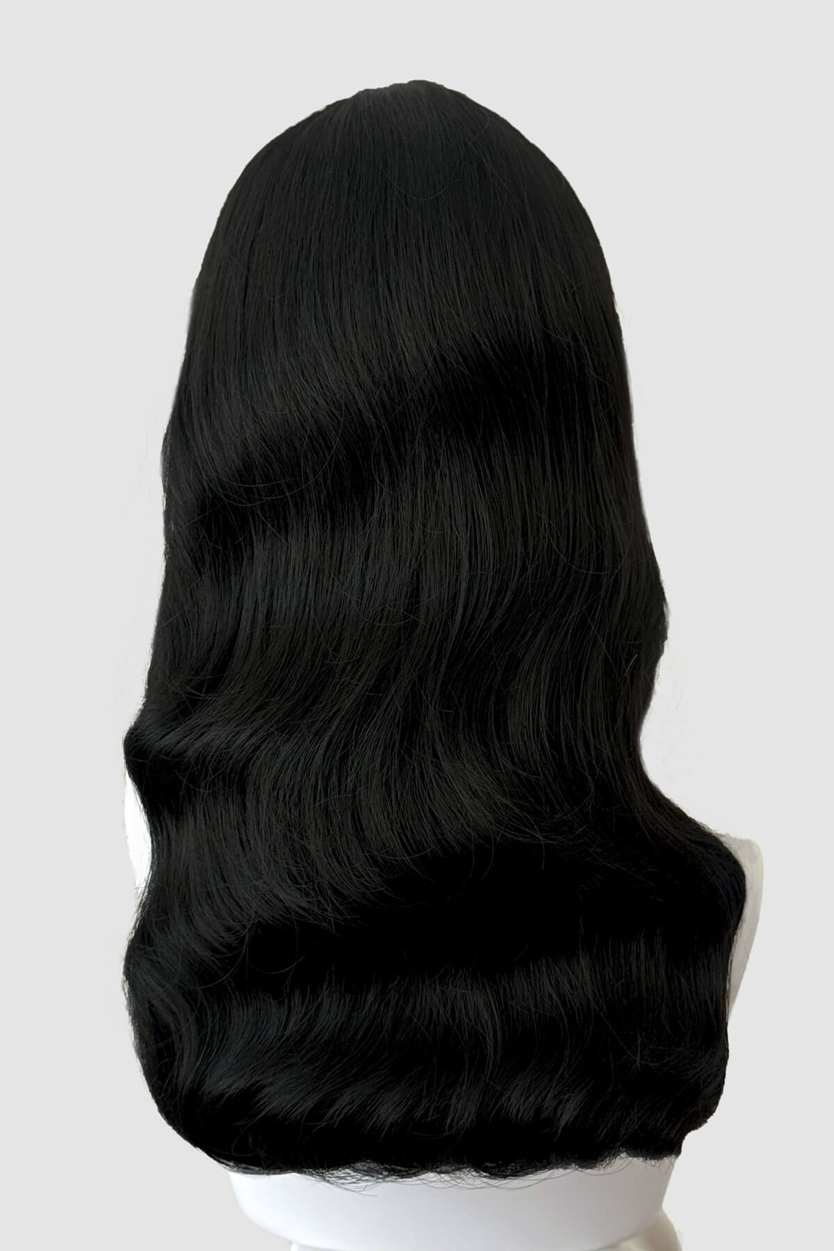 Black wig on a mannequin head against a white background. Black pinup style wig, old Hollywood waves with short fringe: Milena