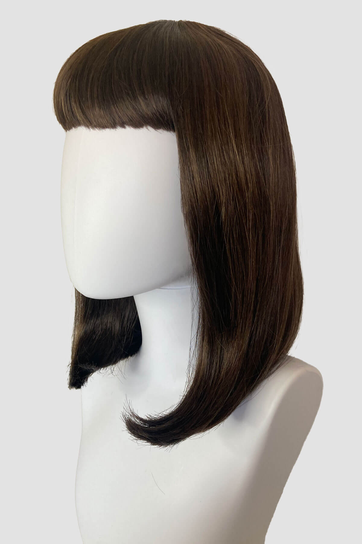 Brown wig on a mannequin head against a white background. Long bob wig with a short fringe, brown with blonde highlights: Jill 8H27