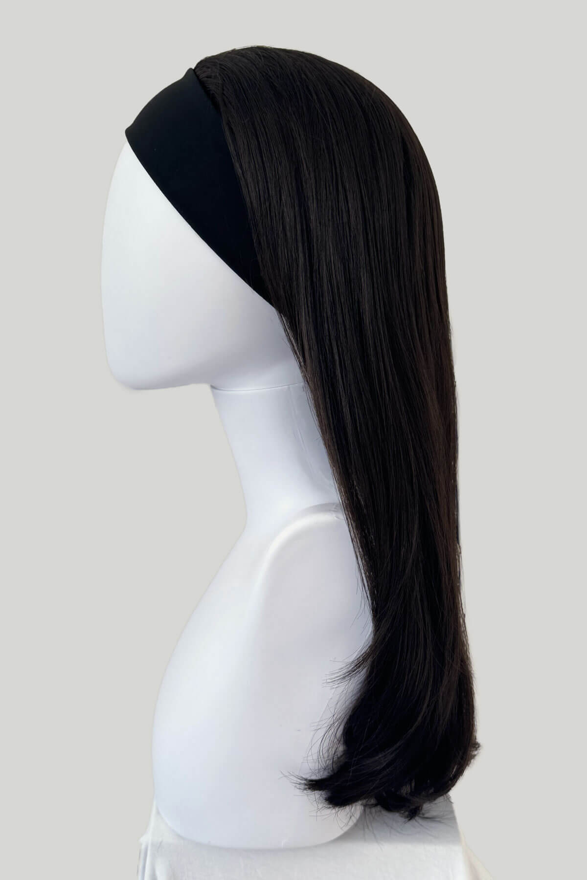 Dark brown wig on a mannequin head against a white background. Headband half wig hairpiece, long and straight: Isla dark brown 4