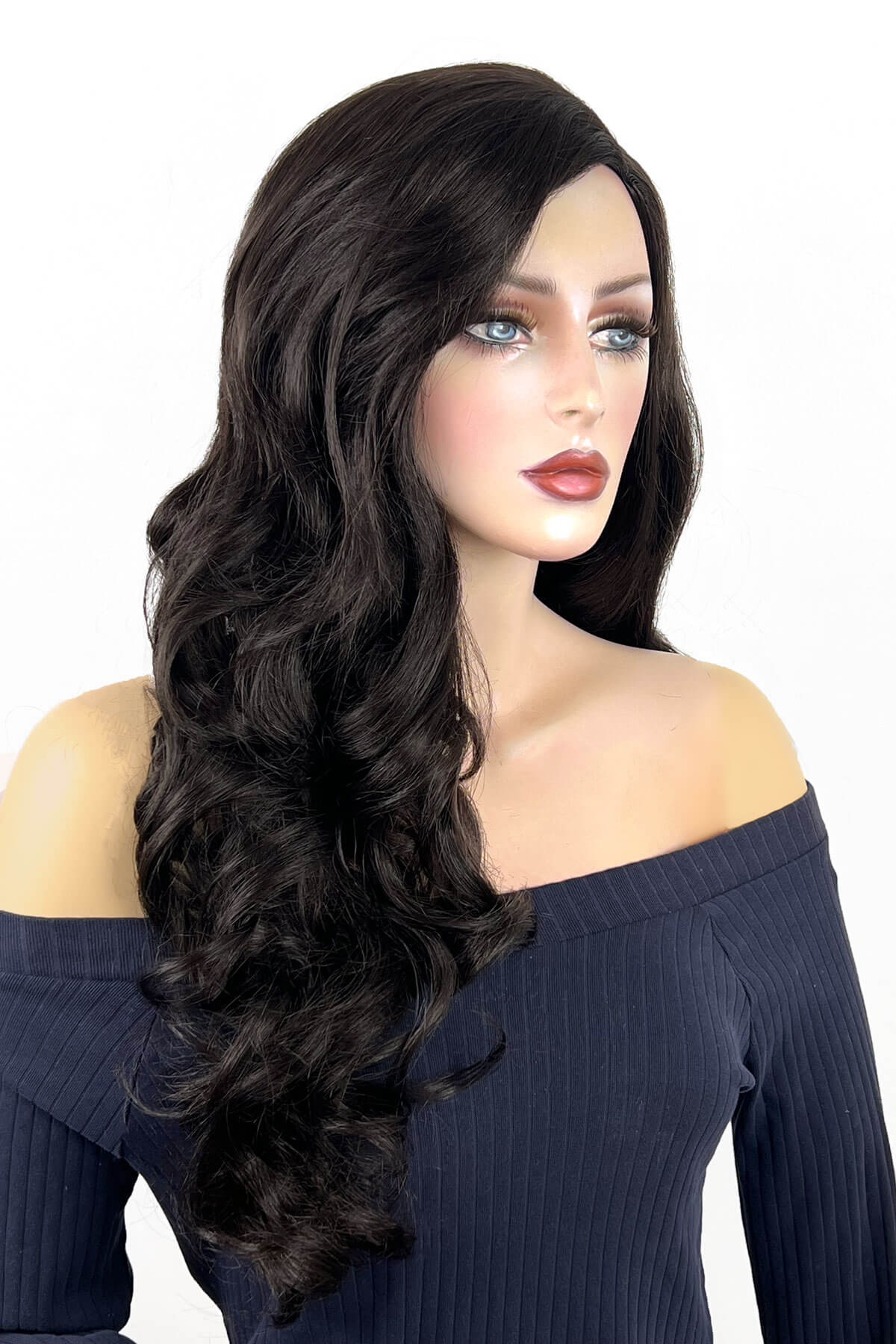 Mannequin head with long dark brown wig on a white background. Long, brown wig, with wonderful loose waves and curls and a sweeping fringe: Leonie