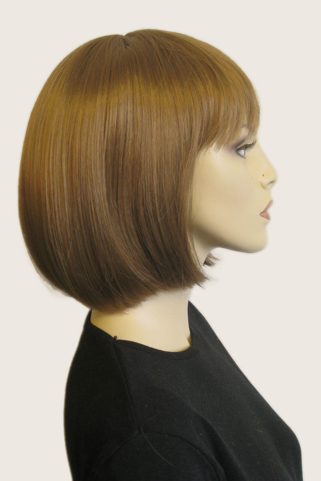 Mannequin head with brown bob haircut on a white background. Brown bob wig, chic and stylish: Honour light brown 27