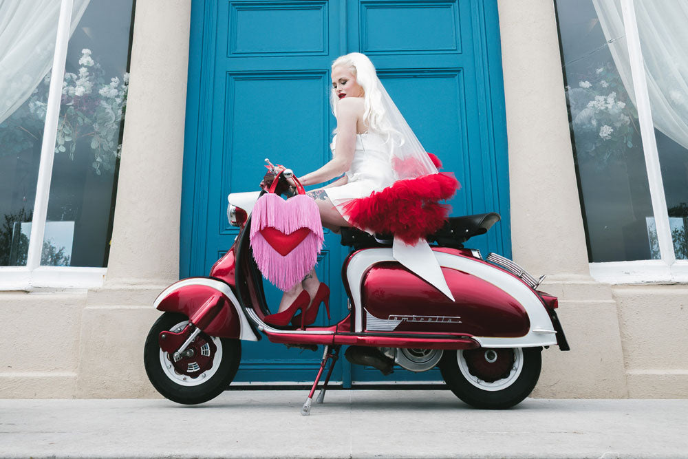 Bride with long blonde hair on a moped