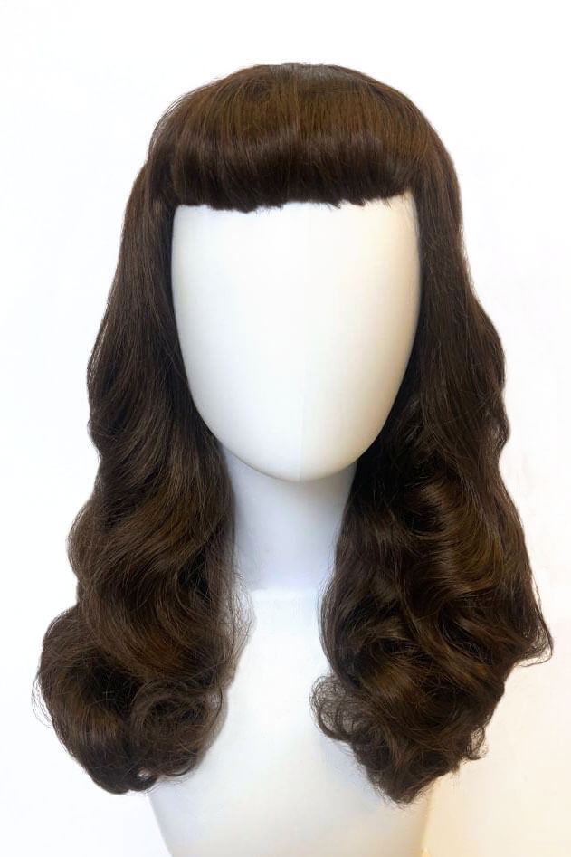 Brown wig with a fringe on a white mannequin head. Brown 1950s pinup style wig, with long waves and a short fringe: Rosie chestnut brown 8